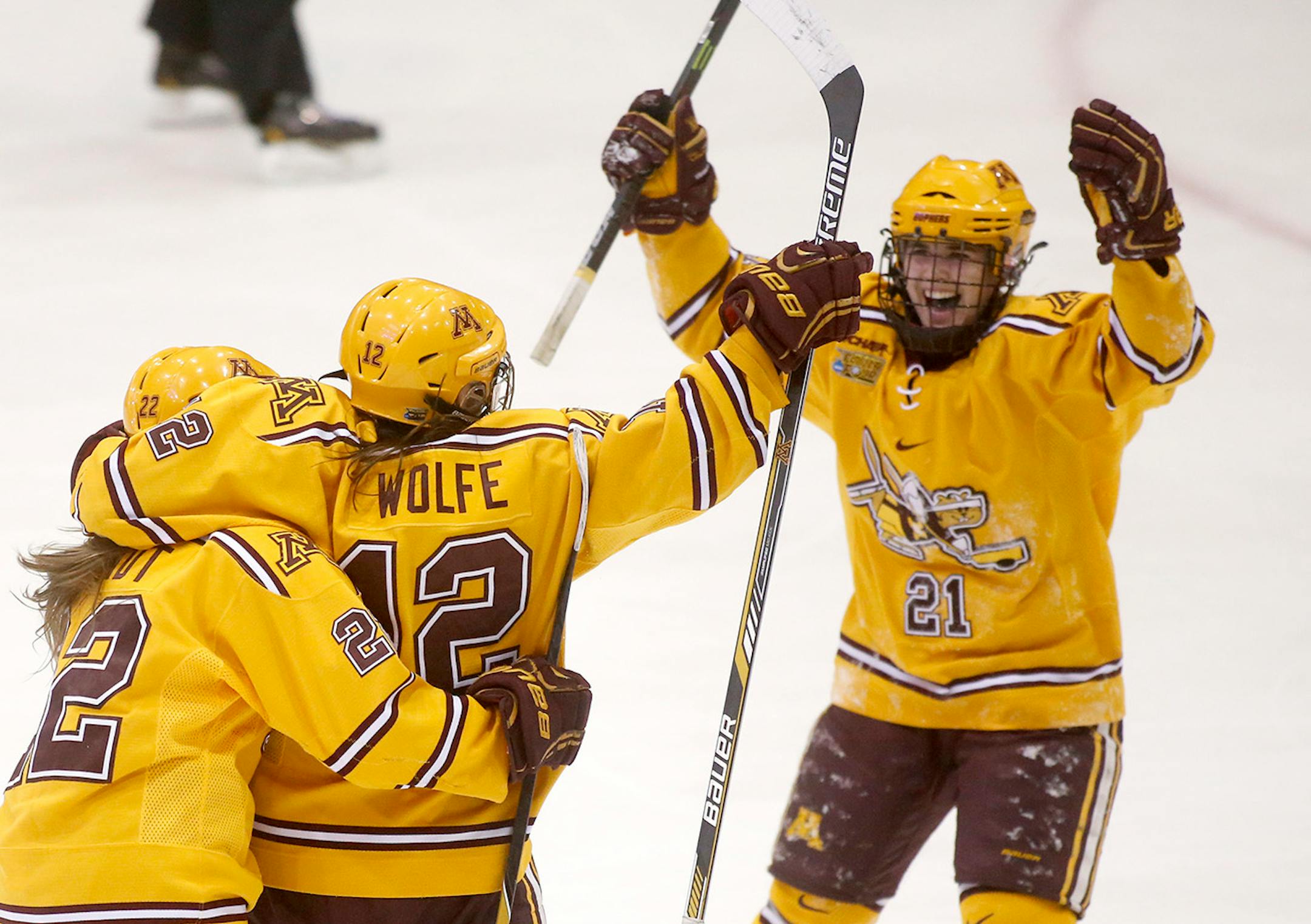 Minnesota's Megan Wolfe (12) celebrates an assist with teammates Hannah Brandt (22) and Dani Cameranesi (21) during the second period of the Gopher's 3-1 win over Wisconsin in the Women's NCAA Frozen Four hockey semifinals Friday, March 20, 2015, at Ridder Arena in Minneapolis.
