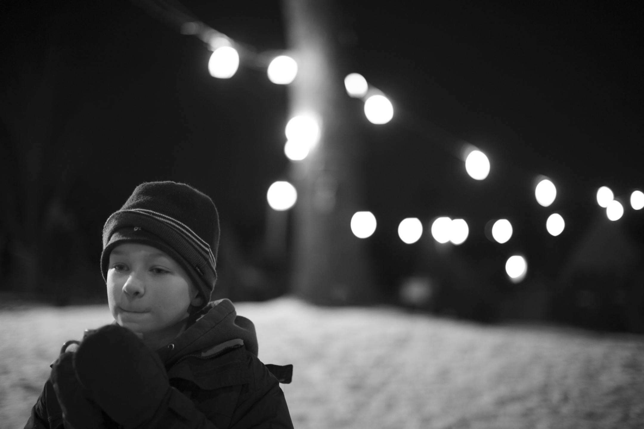 Christian Kunau, 11, sipped hot chocolate while working at the Troop 103 Christmas tree lot Friday evening. The lot opened for business lst Friday. It was Christian's first year working at the lot. The hardest part about working there, he said, "is untying the trees and naming them." "The money goes to Troop 103 and helps us so everyone can go to camp," he explained. "It's not that cold, but it gets cold when it gets darker, " he said.