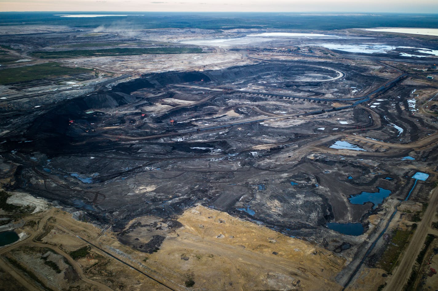 -- PHOTO MOVED IN ADVANCE AND NOT FOR USE - ONLINE OR IN PRINT - BEFORE NOV. 13, 2016. -- FILE -- An oil sands strip mine, north of Fort McMurray, Alberta, Canada, Aug. 28, 2015. For a nation dependent on natural resources, the global downturn around oil and other commodities hurt, but Prime Minister Justin Trudeau&#xd5;s plan to spur growth has buoyed optimism in Canada. (Ian Willms/The New York Times) ORG XMIT: XNYT2