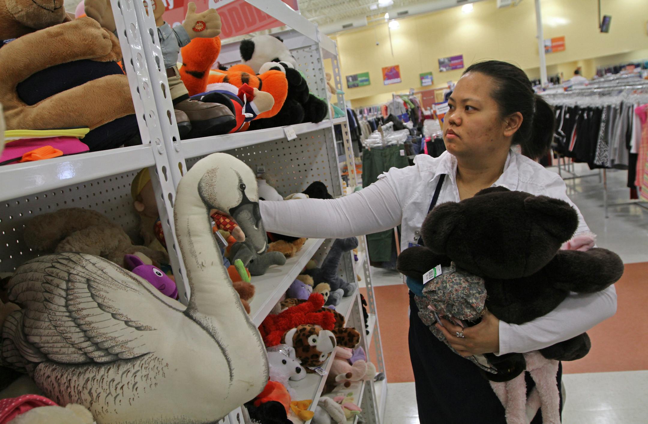 Goodwill employee Linda Vue stocked the plush toy shelves at the new Goodwill store at 5660 Main St NE in Fridley. Photographed on 3/28/13.] Bruce Bisping/Star Tribune bbisping@startribune.com Linda Vue/source