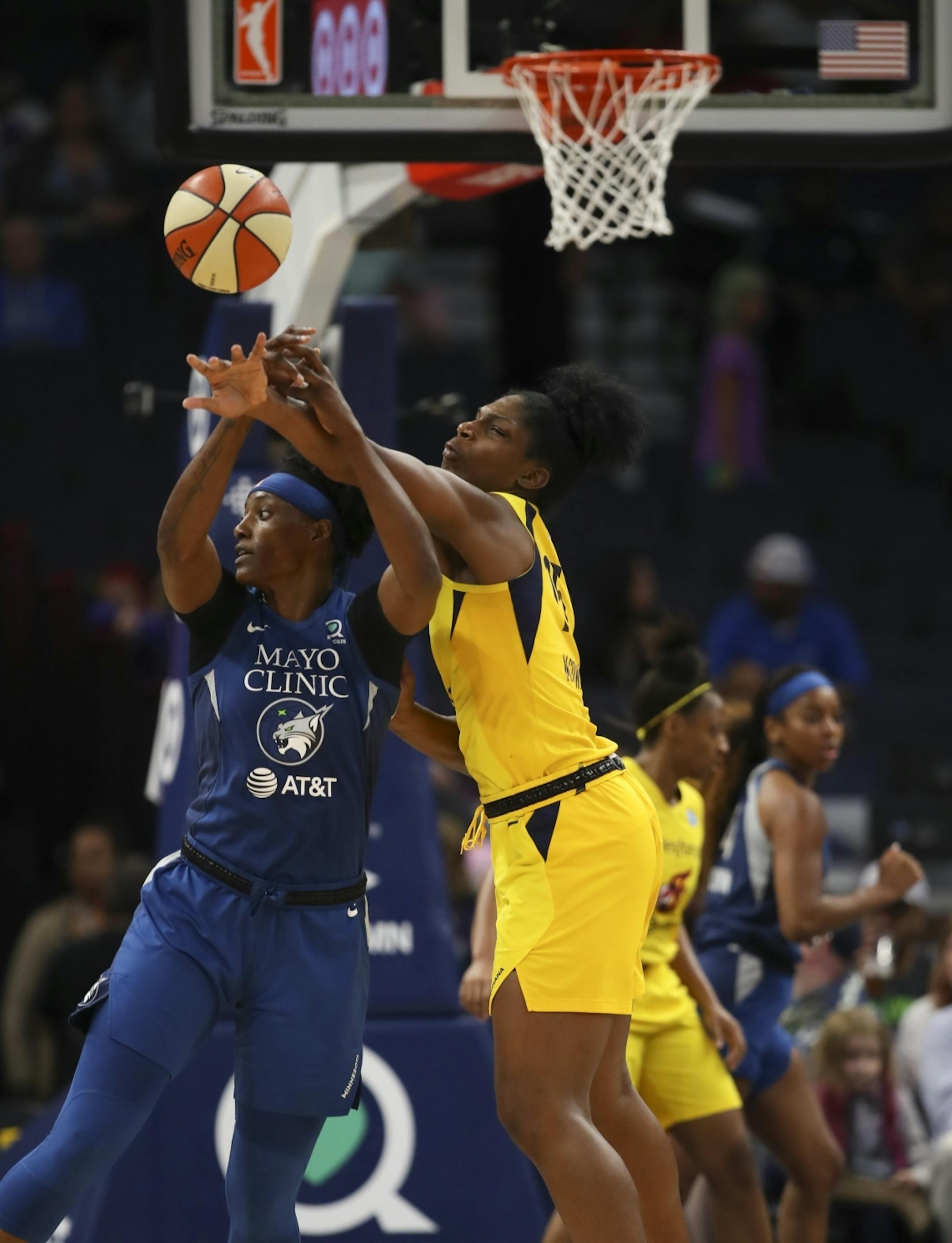 Indiana Fever center Teaira McCowan (15) deflected a fourth quarter pass intended for Minnesota Lynx center Sylvia Fowles (34) for a turnover.