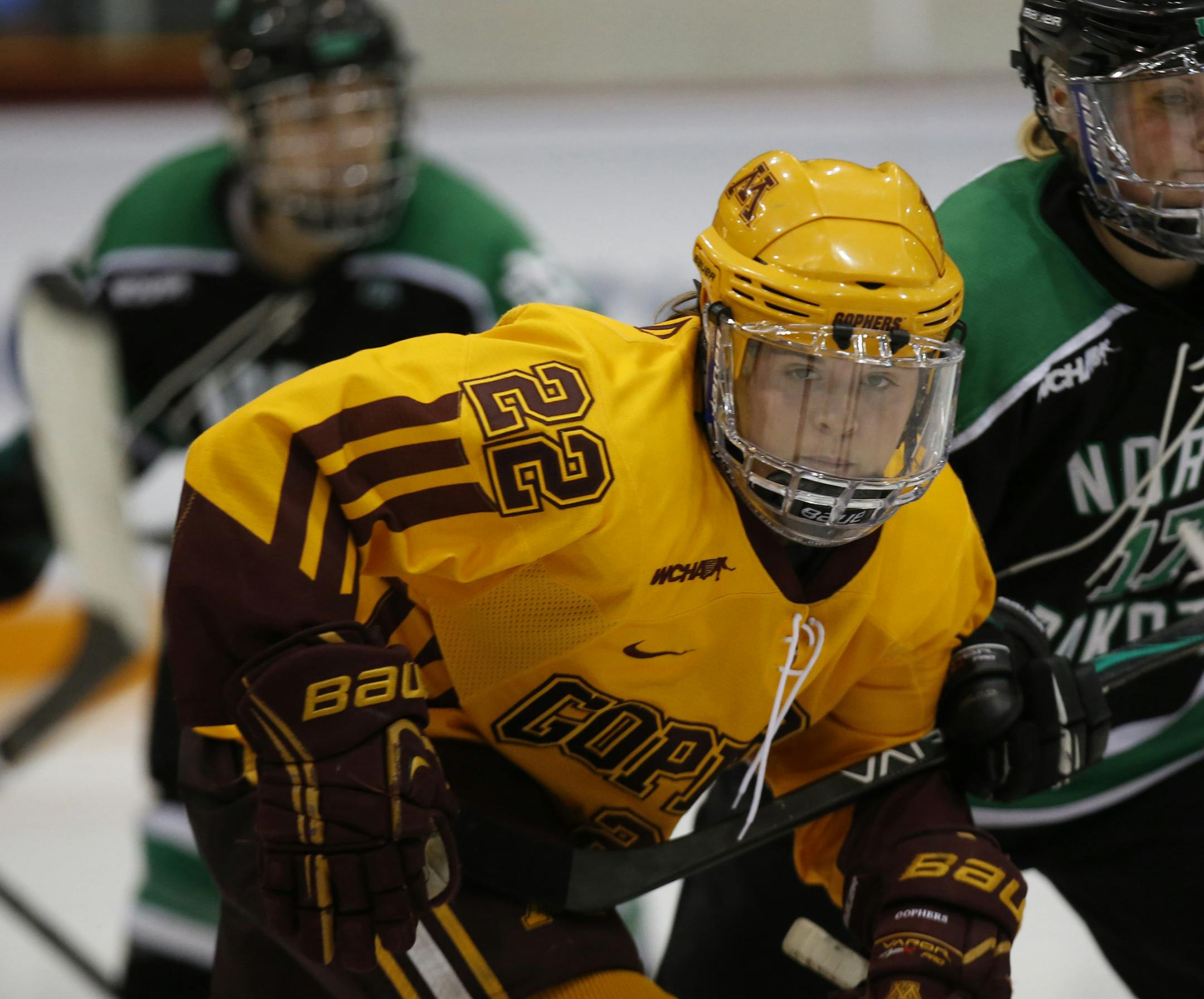 Gopher vs. North Dakota, Ridder Arena, 3/16/13. (left to right) Gophers Hannah Brandt and Jocelyne Lamoureux battled for the puck.] Bruce Bisping/Star Tribune bbisping@startribune.com Hannah Brandt, Jocelyne Lamoureux/roster. ORG XMIT: MIN1303162127590800