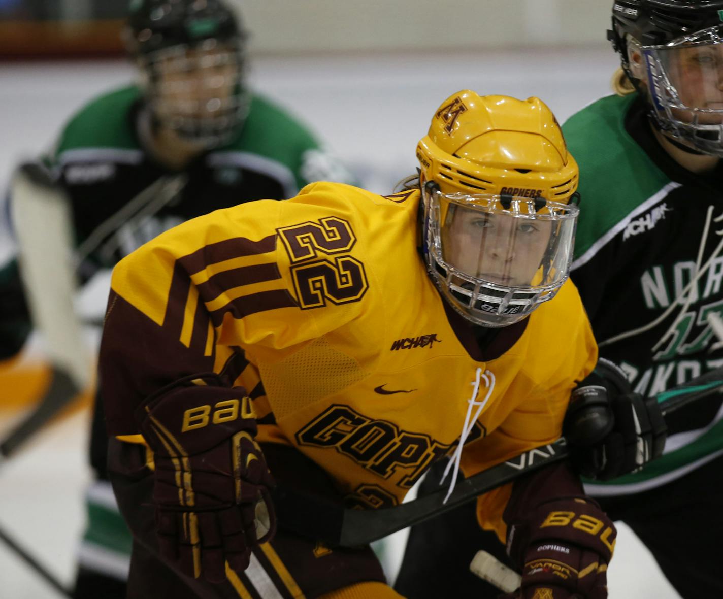 Gopher vs. North Dakota, Ridder Arena, 3/16/13. (left to right) Gophers Hannah Brandt and Jocelyne Lamoureux battled for the puck.] Bruce Bisping/Star Tribune bbisping@startribune.com Hannah Brandt, Jocelyne Lamoureux/roster. ORG XMIT: MIN1303162127590800