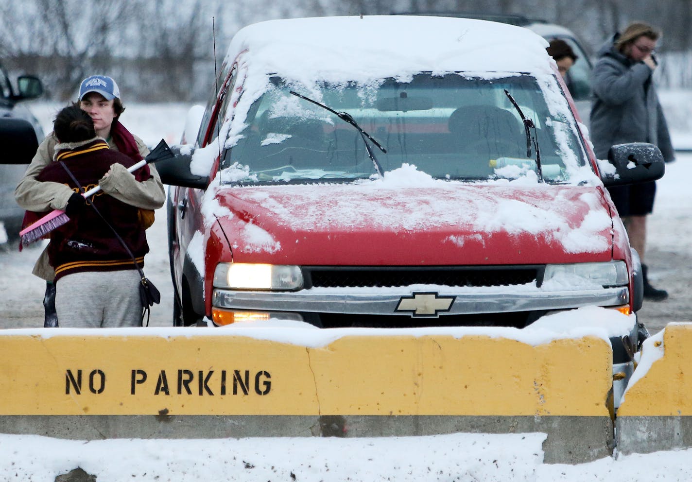 Minneapolis resident Coltin Paddock hugs his girlfriend Kelli Lukkonene outside the city of Minneapolis auto impound lot Wednesday, Dec. 30, 2015, in Minneapolis, MN. The couple had both their vehicles towed, including Paddock's 2002 Chevy Silverado truck, from Como SE Avenue and paid $276 to get them out. "I'm about to go broke," said Paddock, an electrician who also plows to make extra money."](DAVID JOLES/STARTRIBUNE)djoles@startribune.com St. Paul and Minneapolis have declared snow emergenci