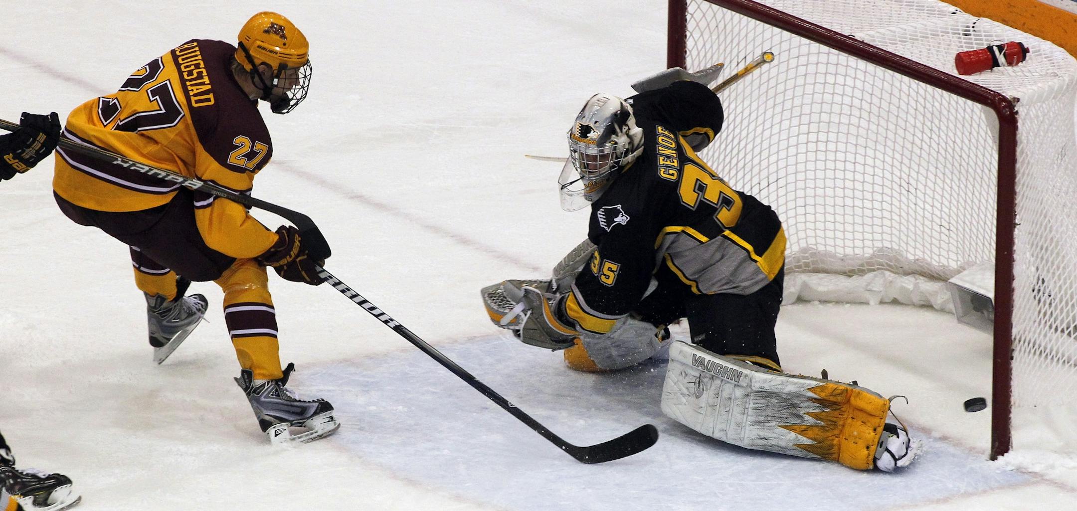Gophers Nick Bjugstad's (27) shot on goal just missed as Michigan Tech's goalie Kevin Genoe defended in first period action.