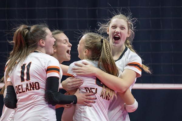 Delano's Kate Halvorson celebrates a game point in the second set during the girls volleyball 3A semifinal match between Delano and Byron at the Xcel 