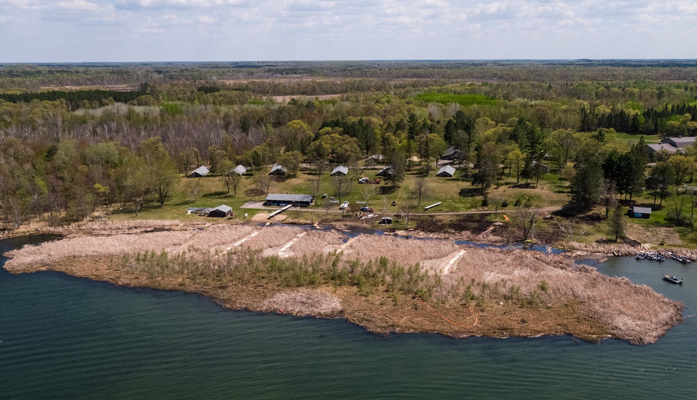 Workers are still trying to move the monster bog on North Long Lake near Brainerd. The bog grounded on the beach at Legionville, a summer camp for school safety guards.