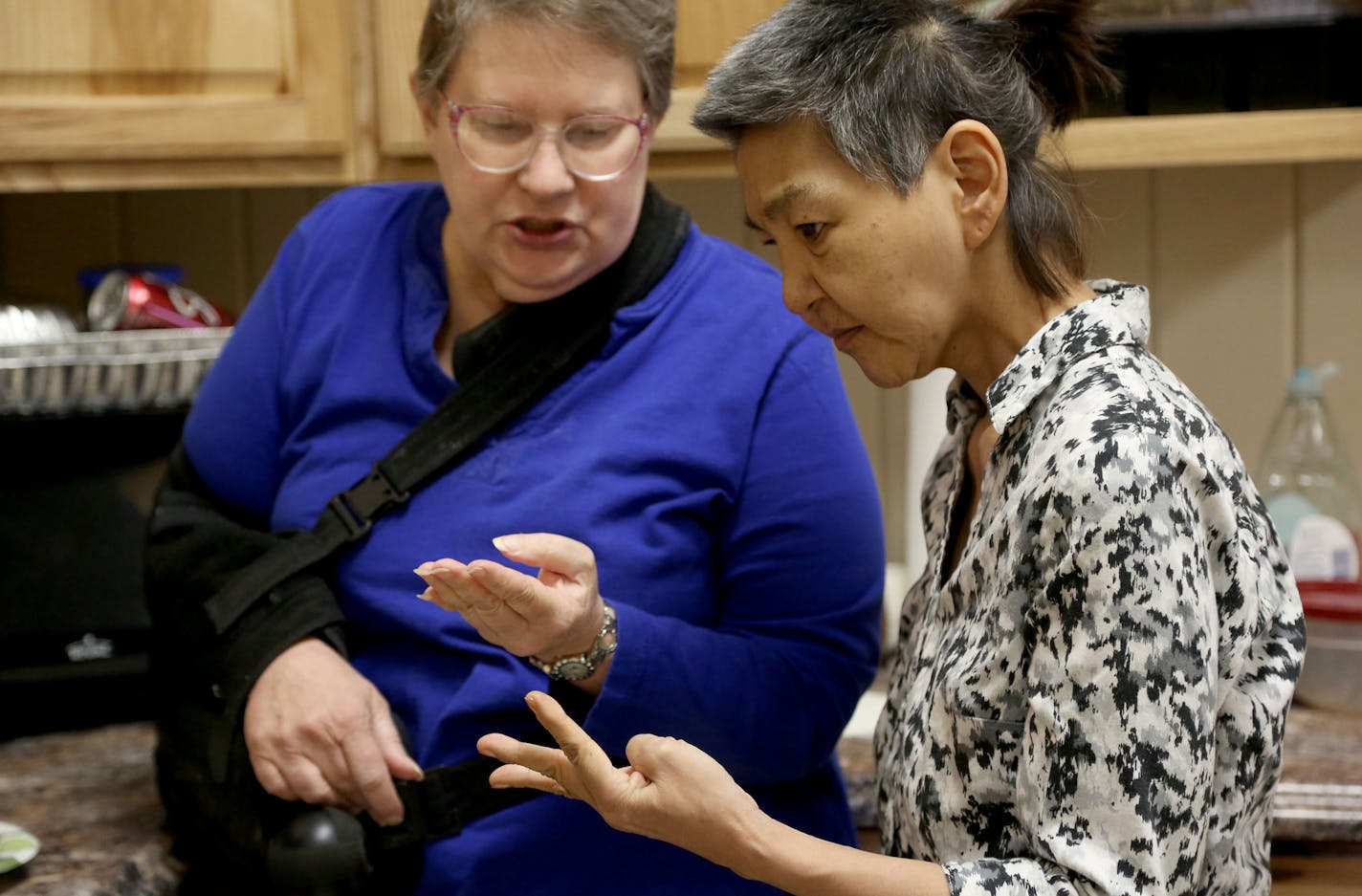 Laura Kwapick asked about the recipe for potato au gratin she she cooked with Linda McFeters during a cooking class at Access North, a center for independent living. ] (KYNDELL HARKNESS/STAR TRIBUNE) kyndell.harkness@startribune.com Visited Access North and a food shelter to talk with residents that depend on disability benefits in Walker Min., Tuesday, December 15, 2015. For a growing number of disabled Minnesotans, a little-known federal fund on the brink of insolvency has become a financial l