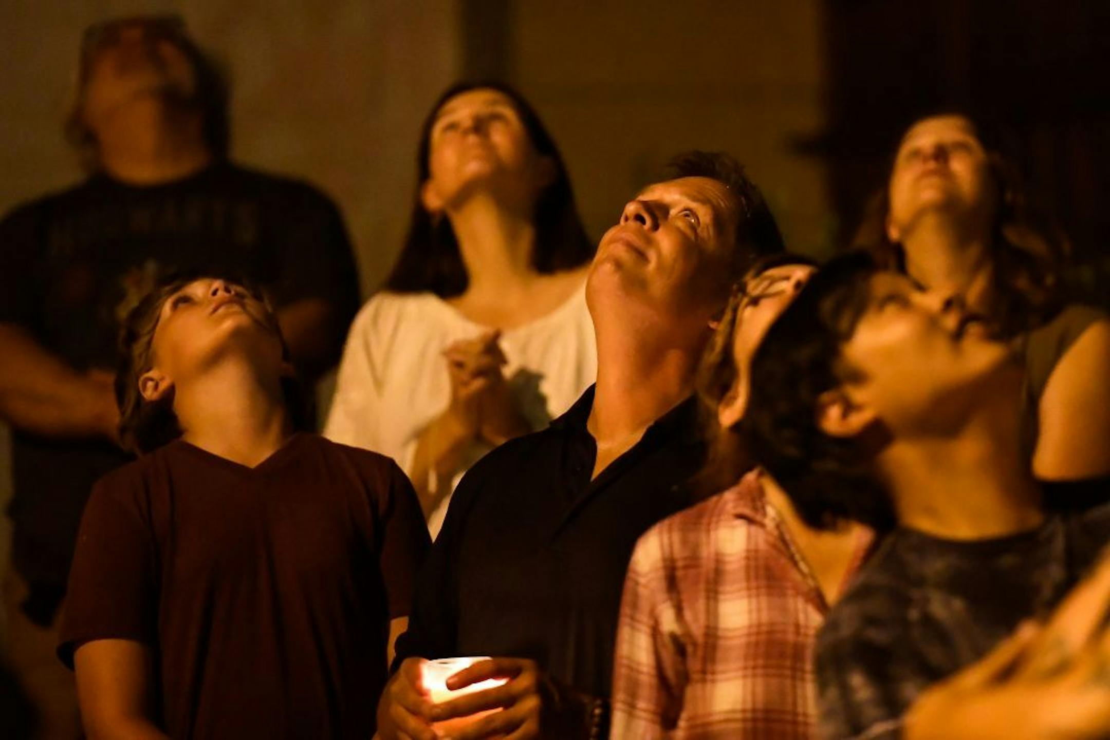 Don Damond, along with friends and neighbors, looked into the sky after the release of a lantern Saturday night during a candlelight vigil memorializing the one year anniversary of Justine Damond Ruszczyk's shooting death by Minneapolis Police officer Mohamed Noor.