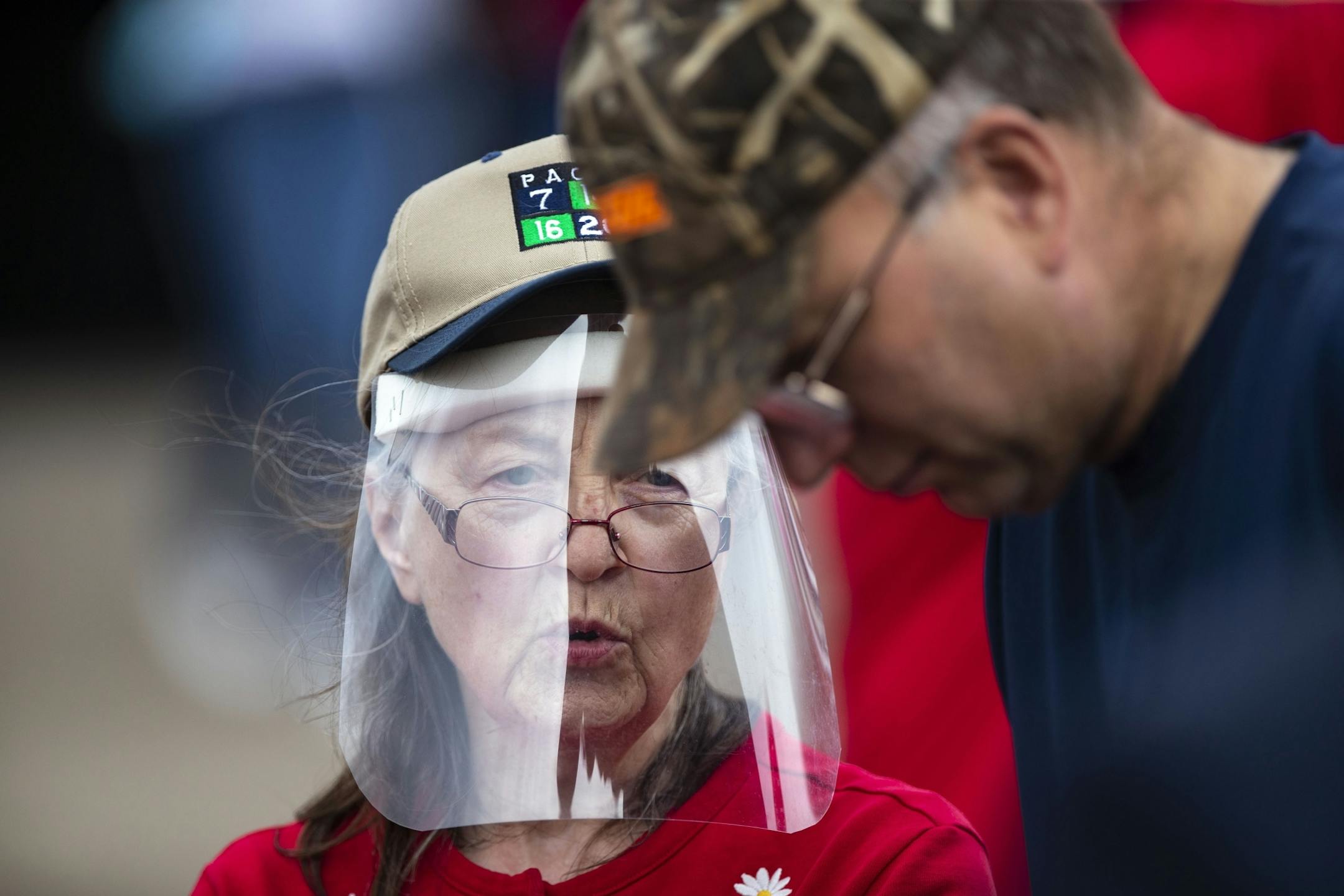 A Trump supporter donned a protective face shield at Mike Pence's campaign event on Friday in Duluth.