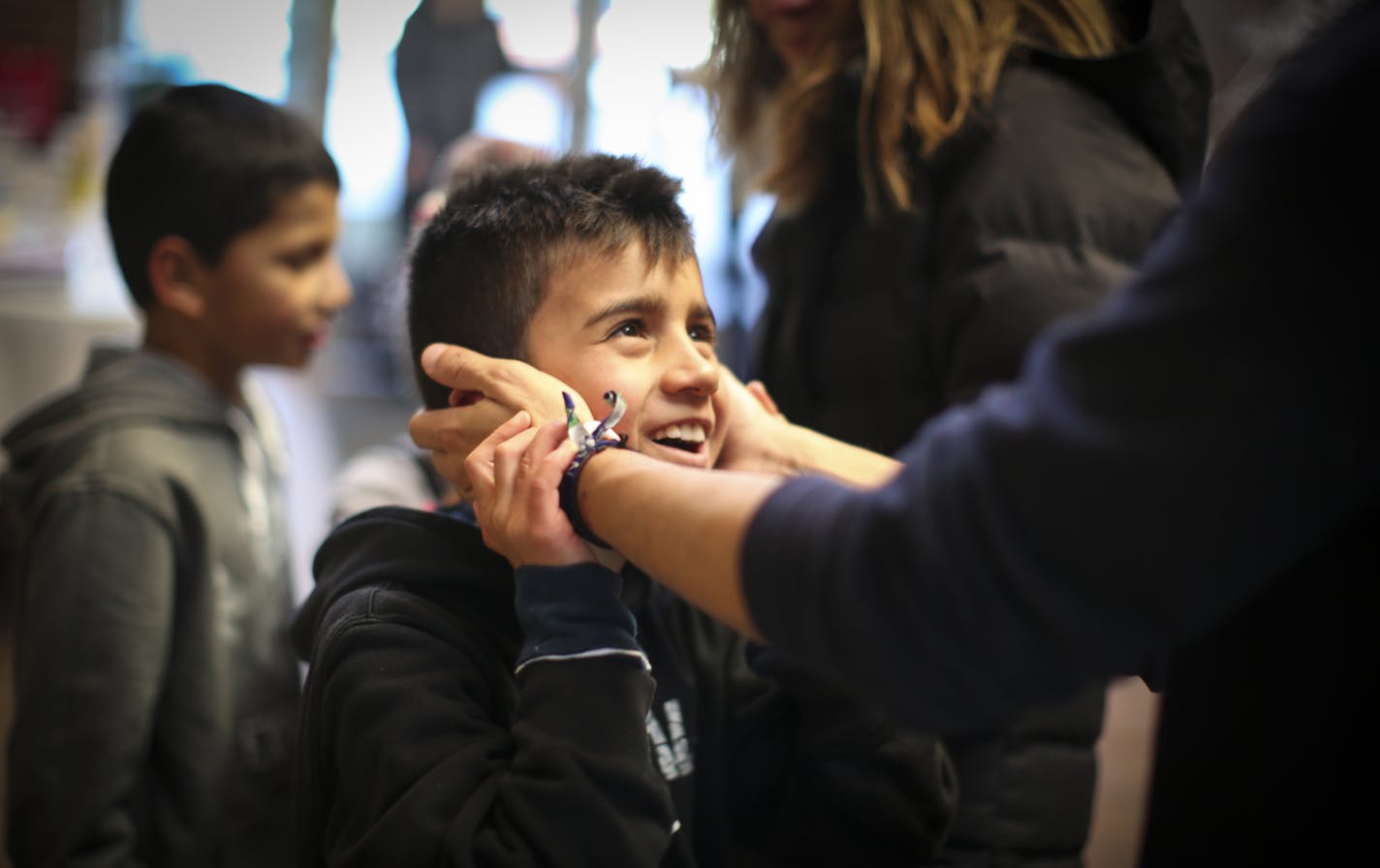 Nine-year-old David had his cheeks warmed up FANA staff member Luis Colorado after playing in the snow for hours at the Ona Orth retreat center in Shoreview, Minn., on Wednesday, December 3, 2014. ] REN&#xc9;E JONES SCHNEIDER reneejones@startribune.com Fourteen orphans from Colombia have been in the Twin Cities since around Thanksgiving, enjoying the holidays -- and hoping to find Minnesota families willing to take them into their homes. Last year, 11 orphans in the program all found a home here