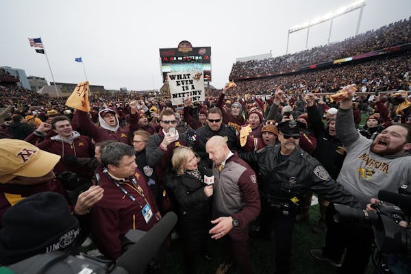 Minnesota Golden Gophers head coach P.J. Fleck was swarmed by fans after the game.