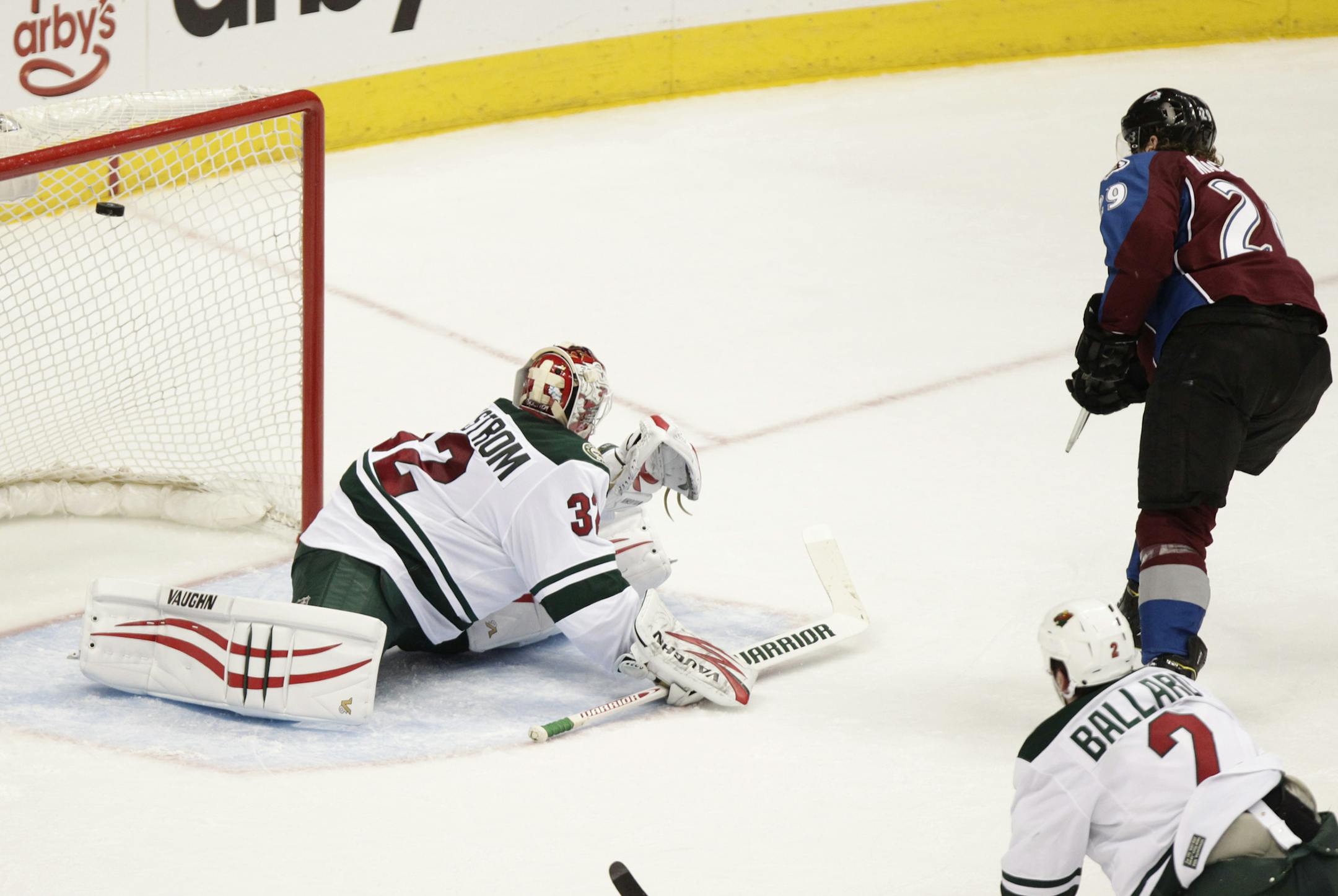 Colorado Avalanche's Nathan MacKinnon (29) scores on Minnesota Wild goalie Niklas Backstrom (32), of Finland, during the third period of an NHL hockey game on Thursday, Jan. 30, 2014 in Denver. The Avalanche won 5-4. (AP Photo/Barry Gutierrez)