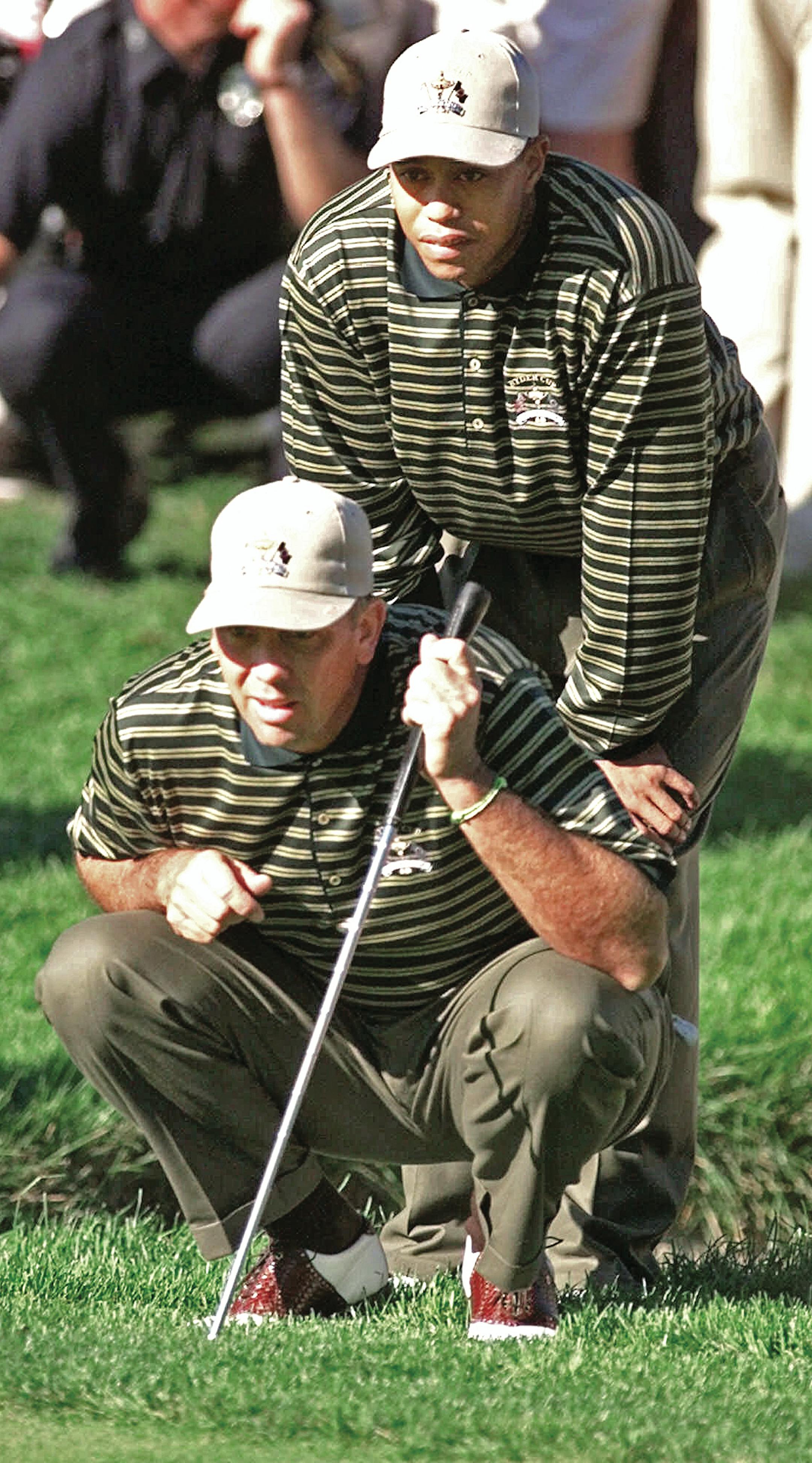 U.S. Ryder Cup playing partners Tom Lehman, kneeling, and Tiger Woods study a putt on the 6th hole of their match with Sergio Garcia and Jesper Parnevik Friday, Sept. 24, 1999, at The Country Club in Brookline, Mass. (AP Photo/Elise Amendola) ORG XMIT: TCC115,TCC115
