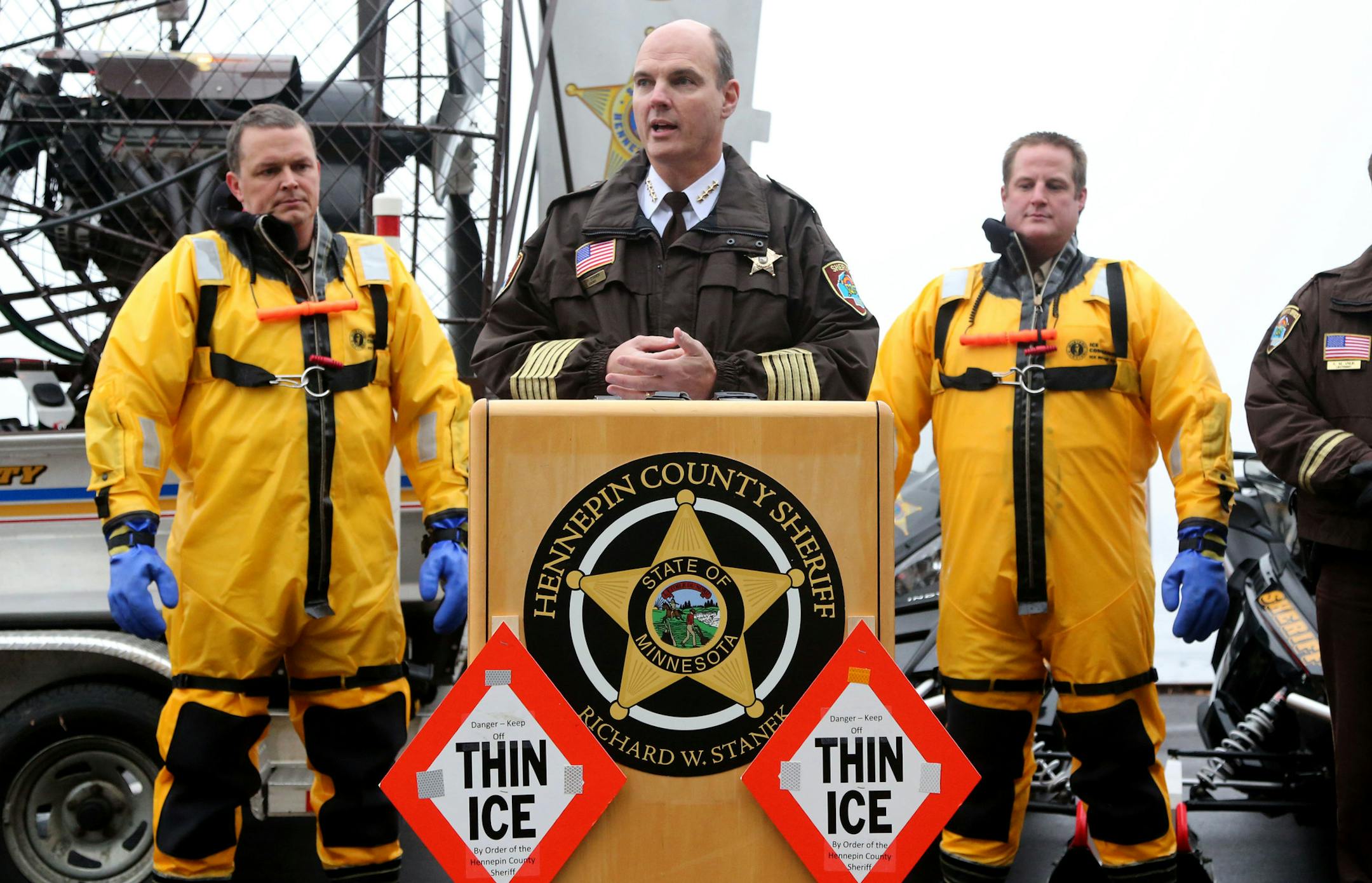 Hennepin County Sheriff Rich Stanek held a press conference on the dangers of thin ice for this holiday season. Members of the department showed off cold water emergency rescue equipment and also demonstrated an icy water rescue. Stanek said ice is not safe for anyone to walk on nor for any vehicles or recreational equipment. Until further notice, Stanek advised everyone to stay off area lakes. Here, Sheriff Stanek addressed media members as deputies Jeremy Gunia, right and Alan Lange, left, wea