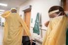 Dr. Todd Struckman put on full body PPE before meeting with a patient who exhibited respiratory symptoms in St. Luke's Emergency Department in Duluth 
