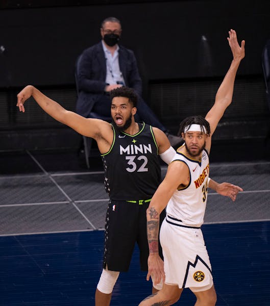 Minnesota Timberwolves center Karl-Anthony Towns (32) watched his first quarter three pointer over Denver Nuggets center JaVale McGee (34) drop throug
