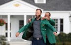 New Masters champion Dustin Johnson got his first green jacket from 2019 winner Tiger Woods after Johnson's record-setting performance at Augusta Nati