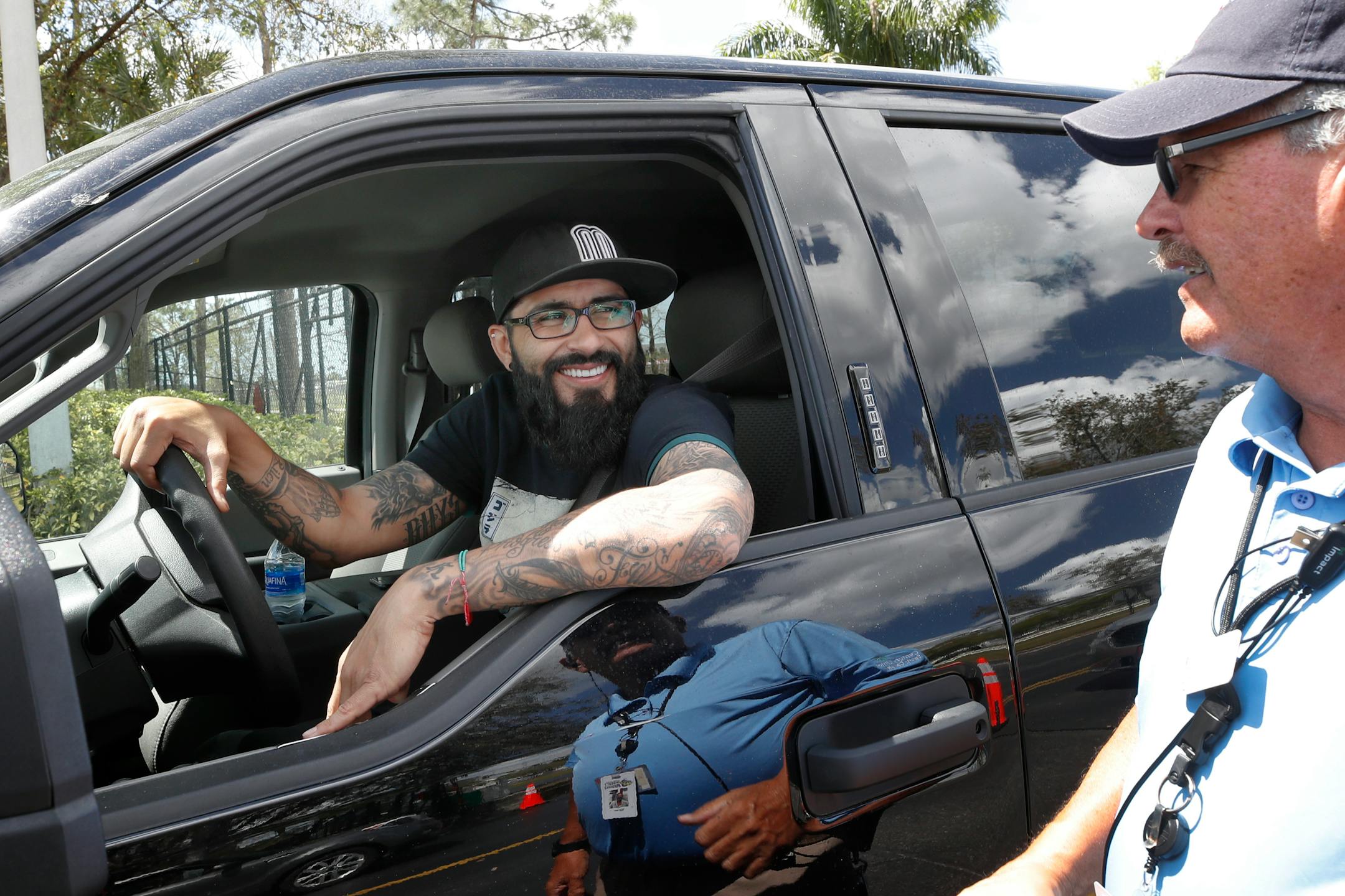 Twins reliever Sergio Romo stopped to say goodbye to Hammond Stadium parking operations worker Bill Fear as Romo left the complex Saturday in Fort Myers, Fla. Major League Baseball has suspended the rest of its spring training game schedule because of the coronavirus outbreak and is also delaying the start of its regular season by at least two weeks.