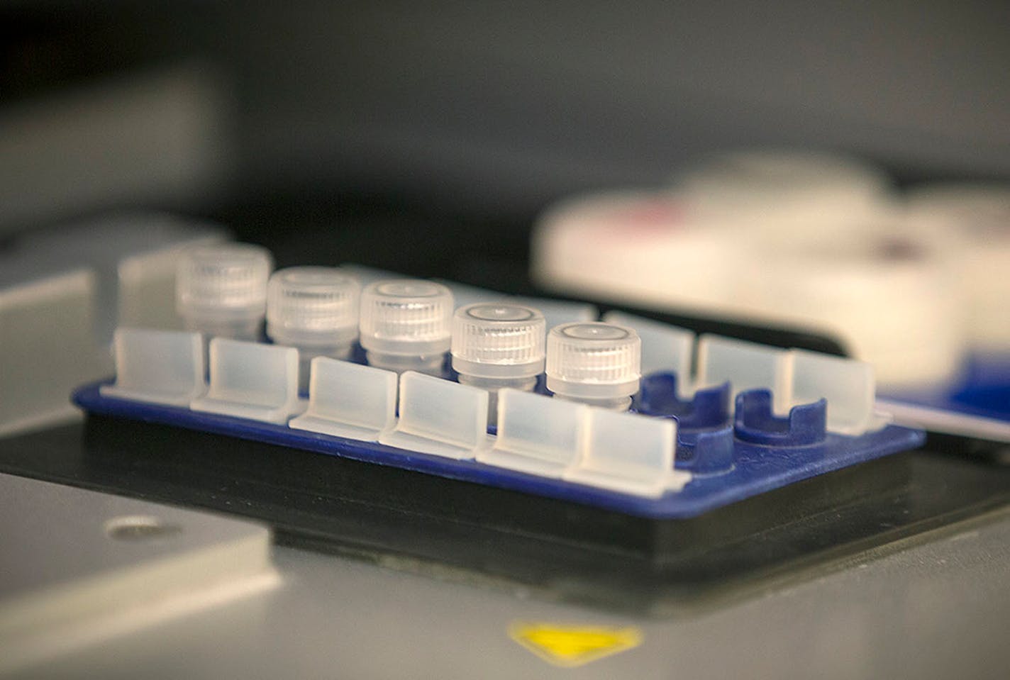 Netsanet Bekele, cq, a clinical lab scientist for the Minnesota Health Department test for measles as he places the tubes into a robot, Thursday, May 11, 2017 at the MHD laboratories in St. Paul, MN.