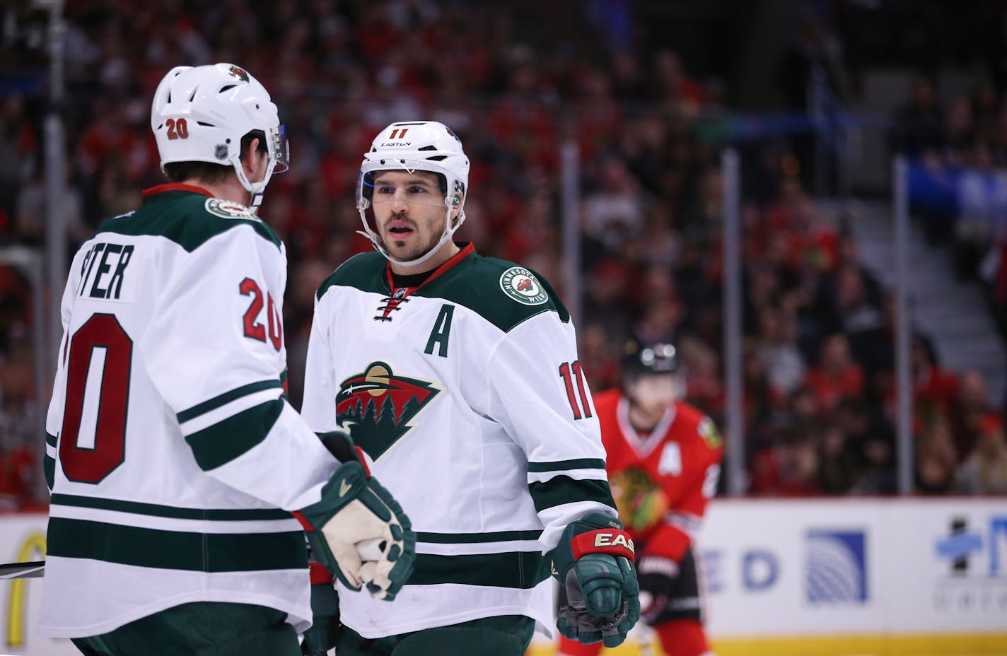 Wild left wing Zach Parise (11) and defenseman Ryan Suter (20) talked before a first period face-off Sunday night in Chicago. ] JEFF WHEELER • jeff.wheeler@startribune.com The Minnesota Wild and the Chicago Blackhawks met in the second game of their NHL playoff series Sunday night, May 3, 2015 at United Center in Chicago.