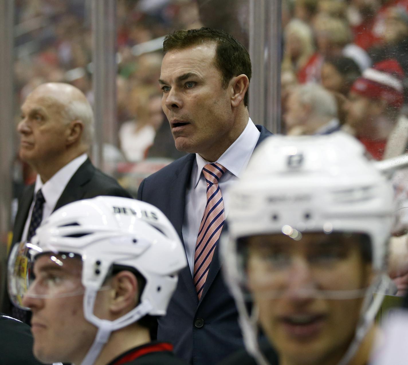 New Jersey Devils coaching staff member Adam Oates, right, stands in the bench area in the third period of an NHL hockey game against the Washington Capitals, Thursday, March 26, 2015, in Washington. The Capitals won 3-2 in overtime. (AP Photo/Alex Brandon) ORG XMIT: VZN10