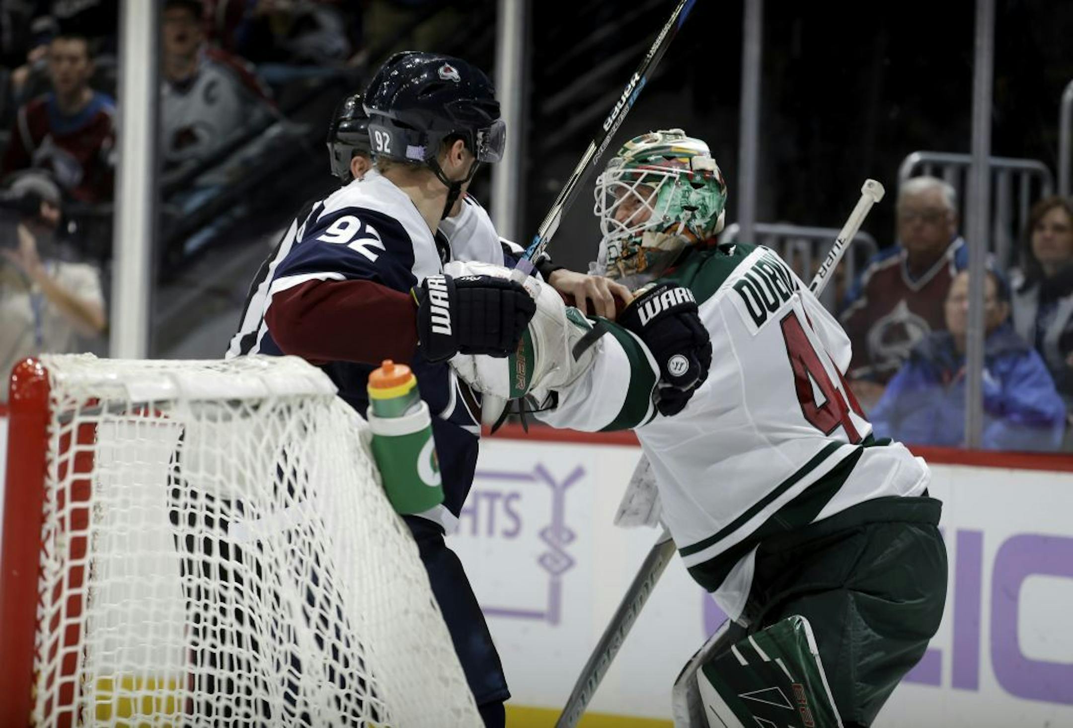 Colorado Avalanche left wing Gabriel Landeskog (92) fights with Minnesota Wild goalie Devan Dubnyk (40) during the third period of an NHL hockey game, Saturday, Nov. 5, 2016, in Denver.