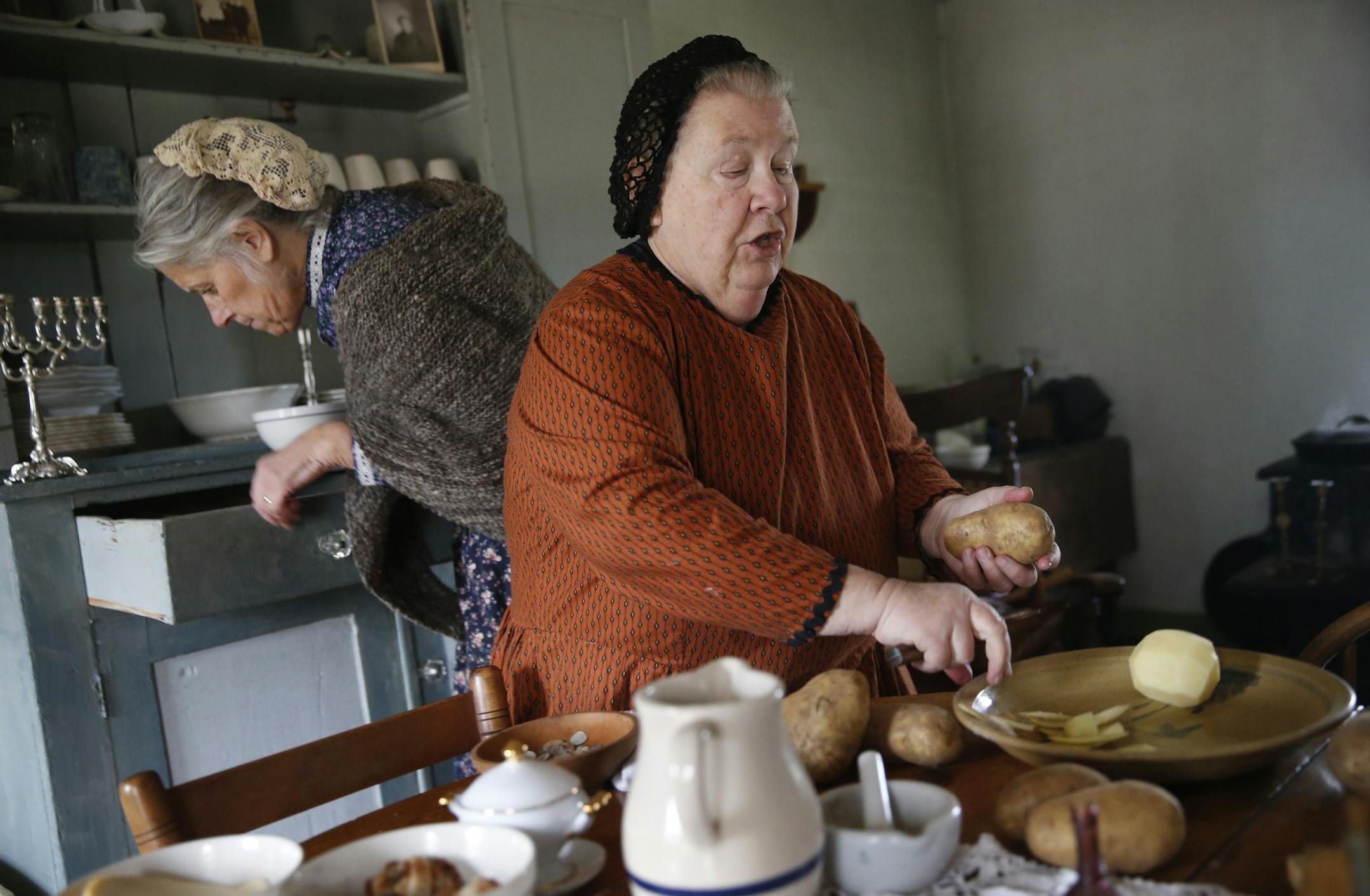 At the 41st Annual Foklways of the Holidays in Shakopee, Miryam Jacobi, right and Mrs. Johnson played by Lynn Ehrke and Lorna Meyers respectively celebrate hannukah in the late 19th centruy. Jacobi is the wife of a Jewish doctor who is making latkes, a potato pancake for the holidays. Jews came from Chicago and abroad to settle the midwest in greater number in the late 19th century .]richard tsong-taatarii/rtsong-taatarii@startribune.com