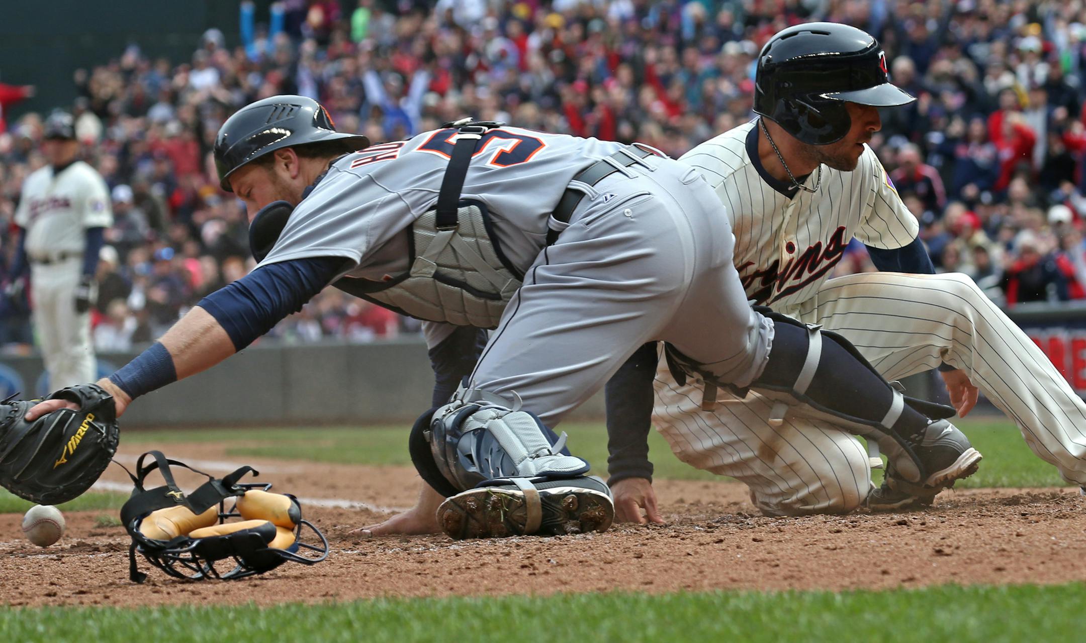 (left to right) Detroit catcher Bryan Holaday dropped the ball as Twins Sam Fuld scored at home plate on an error on the play by the catcher in the 5th inning.] Minnesota vs. Detroit, Target Field, 4/26/14.] Bruce Bisping/Star Tribune bbisping@startribune.com Bryan Holaday, Sam Fuld/roster