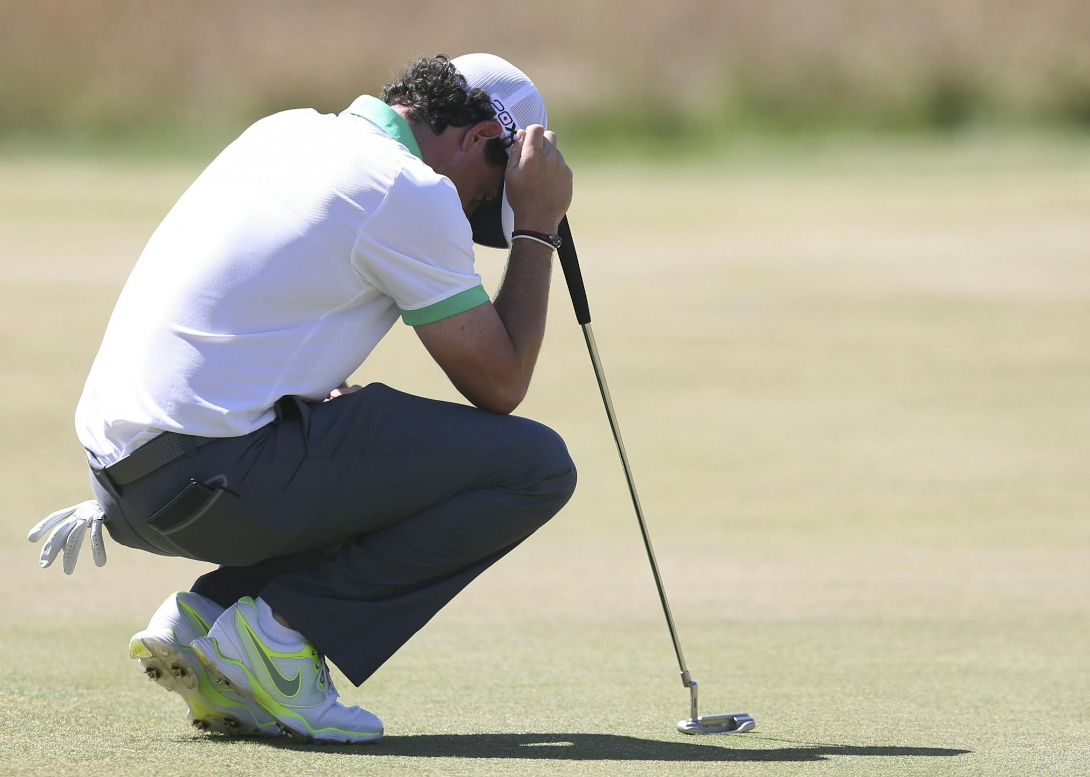 Rory McIlroy of Northern Ireland reacts after putting during the first round of the British Open Golf Championship at Muirfield, Scotland, Thursday July 18, 2013.