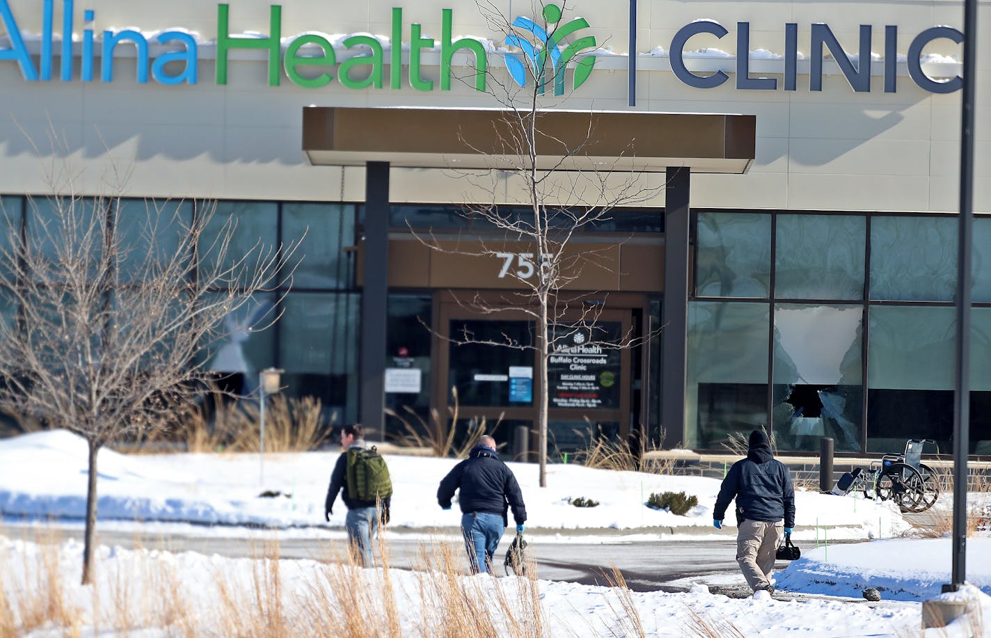 Law enforcement personnel walk toward the Allina Health clinic on Tuesday, Feb. 9, 2021, in Buffalo, Minn. Authorities say multiple people were shot at the clinic Tuesday and a suspect was taken into custody afterward. (David Joles/Minneapolis Star Tribune/TNS) ORG XMIT: 8243731W