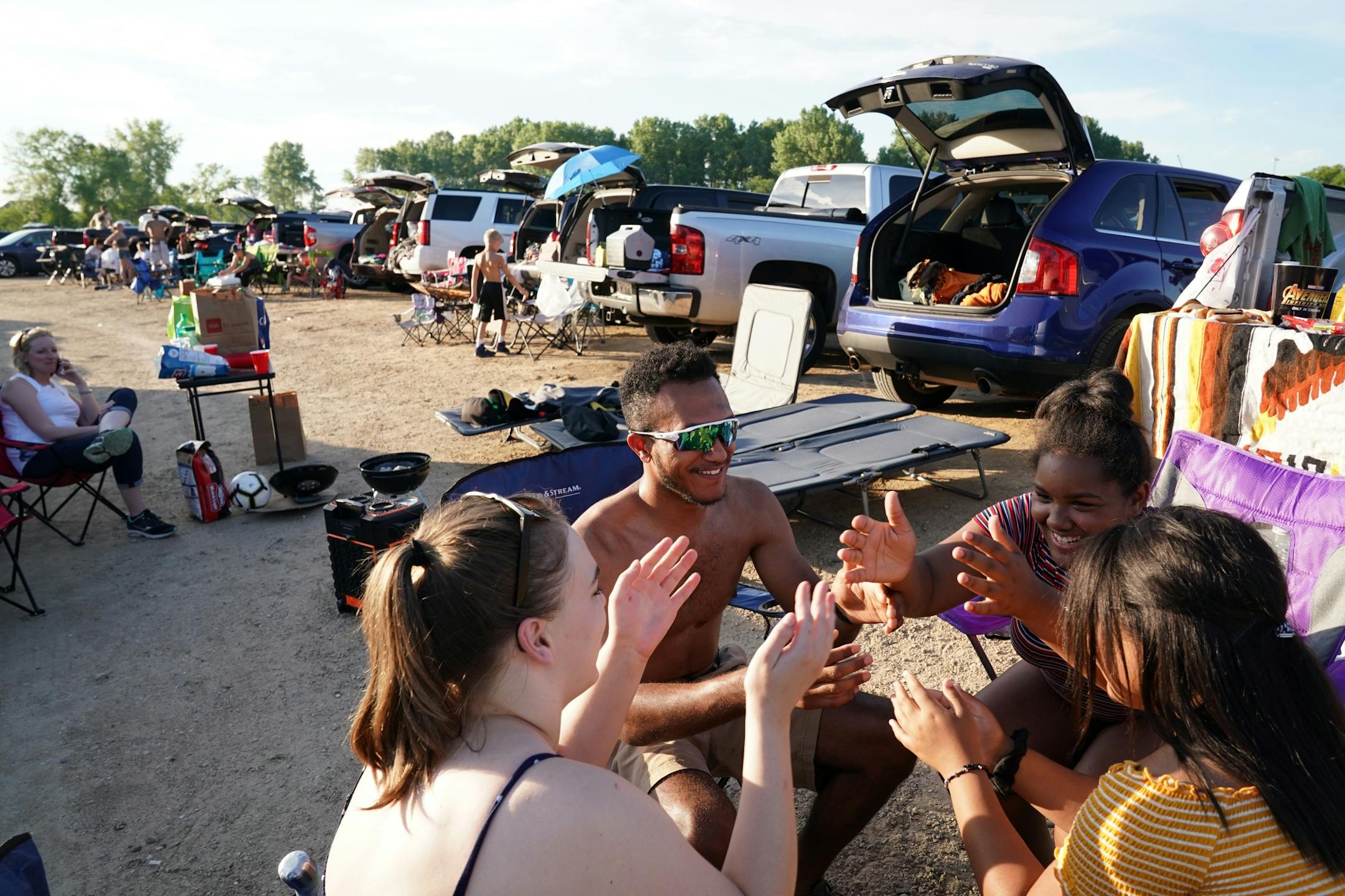 From left, Keanna Wyro, Cordell McLean, Aniya Cook and Aeriyanna Cook played a game as they passed the time waiting for Friday night's show to start.