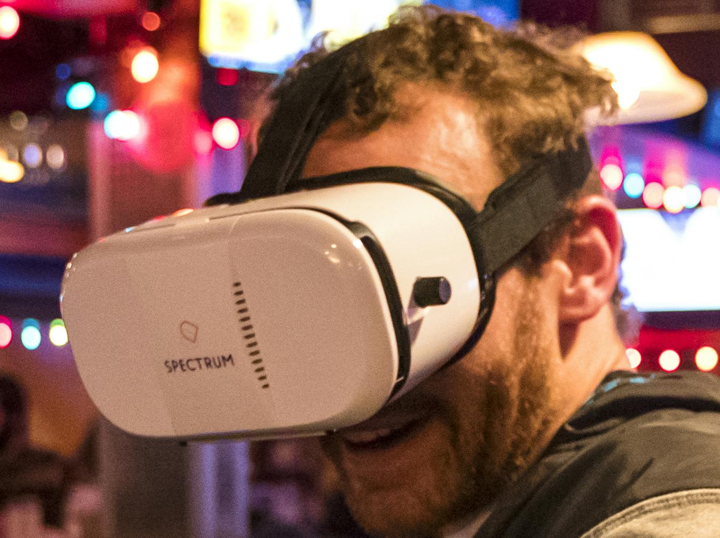 Patrick Quinn used googles to take a virtual tour of Spectrum Apartments at a CPM Companies hosted pop-up virtual reality event at Burrito Loco bar in Dinkytown to promote their new Spectrum Apartments on Thursday, February 23, 2017, in Minneapolis, Minn. At right is Alethea Morrissey who was at the bar with Quinn. ] RENEE JONES SCHNEIDER &#xa5; renee.jones@startribune.com