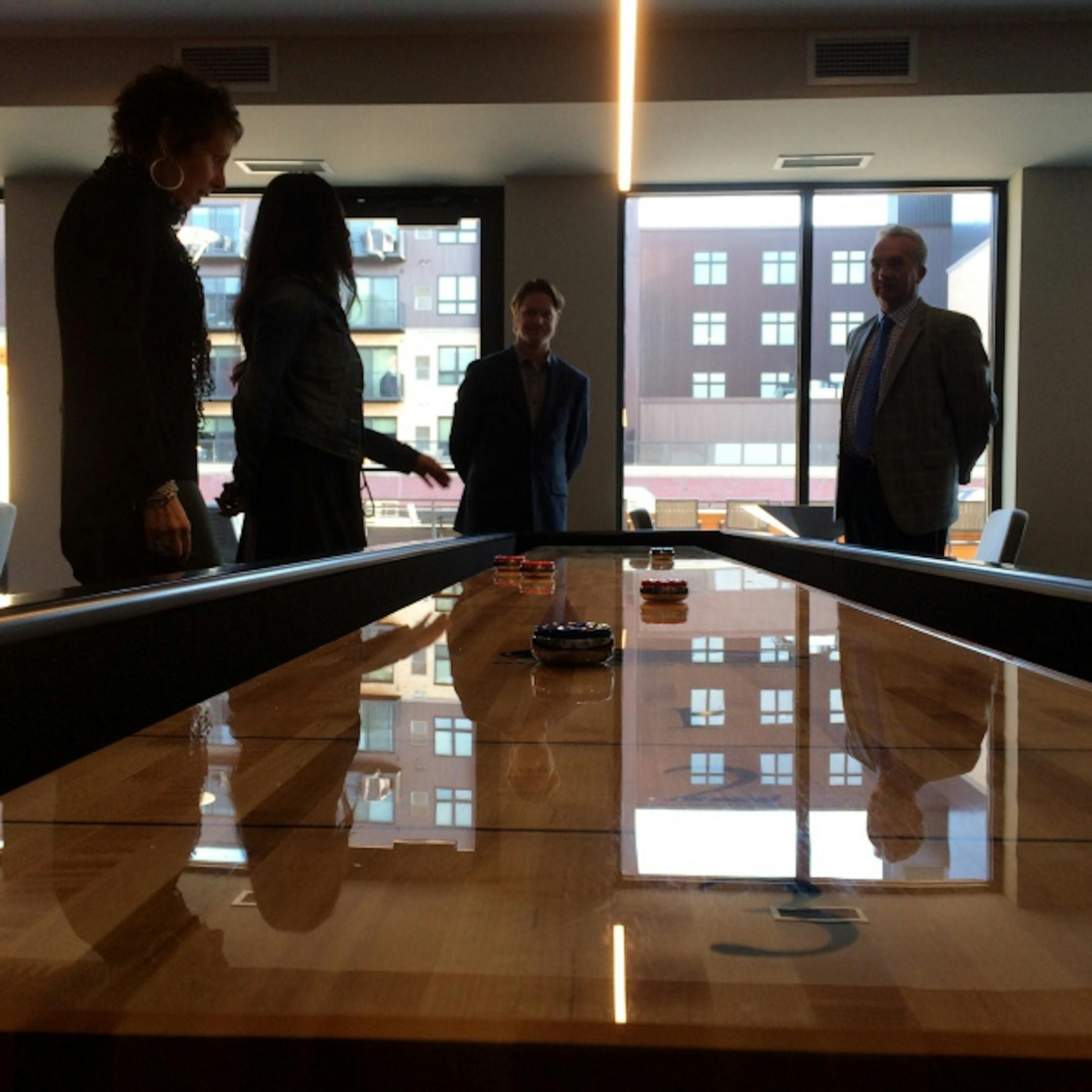 Shuffleboard anyone? Builder owners, Paola and Luigi Bernadi of Sentinel Management and Aurora Investments; site manager, Amanda Kelzenberg and Nick Murnane, real estate manager for Opus Development.