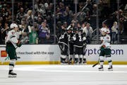Members of the Kings celebrate after center Phillip Danault (24) scored a first-period goal in L.A.'s 6-0 rout of the Wild on Wednesday night.