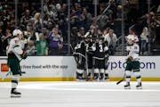 Members of the Kings celebrate after center Phillip Danault (24) scored a first-period goal in L.A.'s 6-0 rout of the Wild on Wednesday night.
