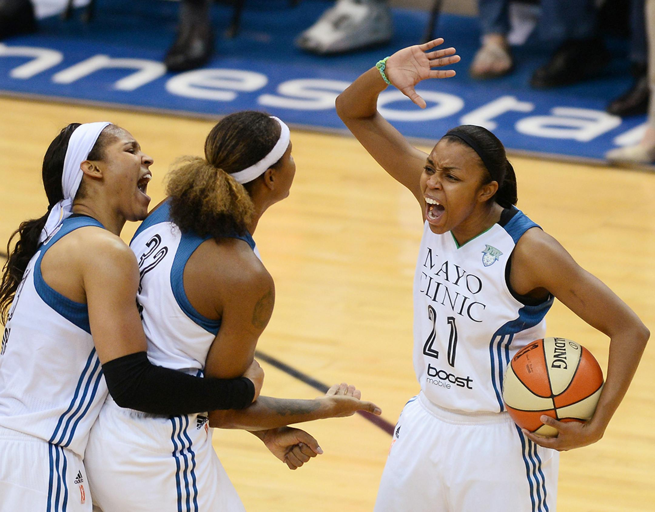Minnesota Lynx guard Renee Montgomery (21), from right, celebrates with Minnesota Lynx forward Rebekkah Brunson (32) and Minnesota Lynx forward Maya Moore (23) during the second half.
