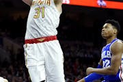 Atlanta Hawks' Mike Muscala (31) past Philadelphia 76ers' Richaun Holmes (22) during the first half of an NBA basketball game, Saturday, Oct. 29, 2016
