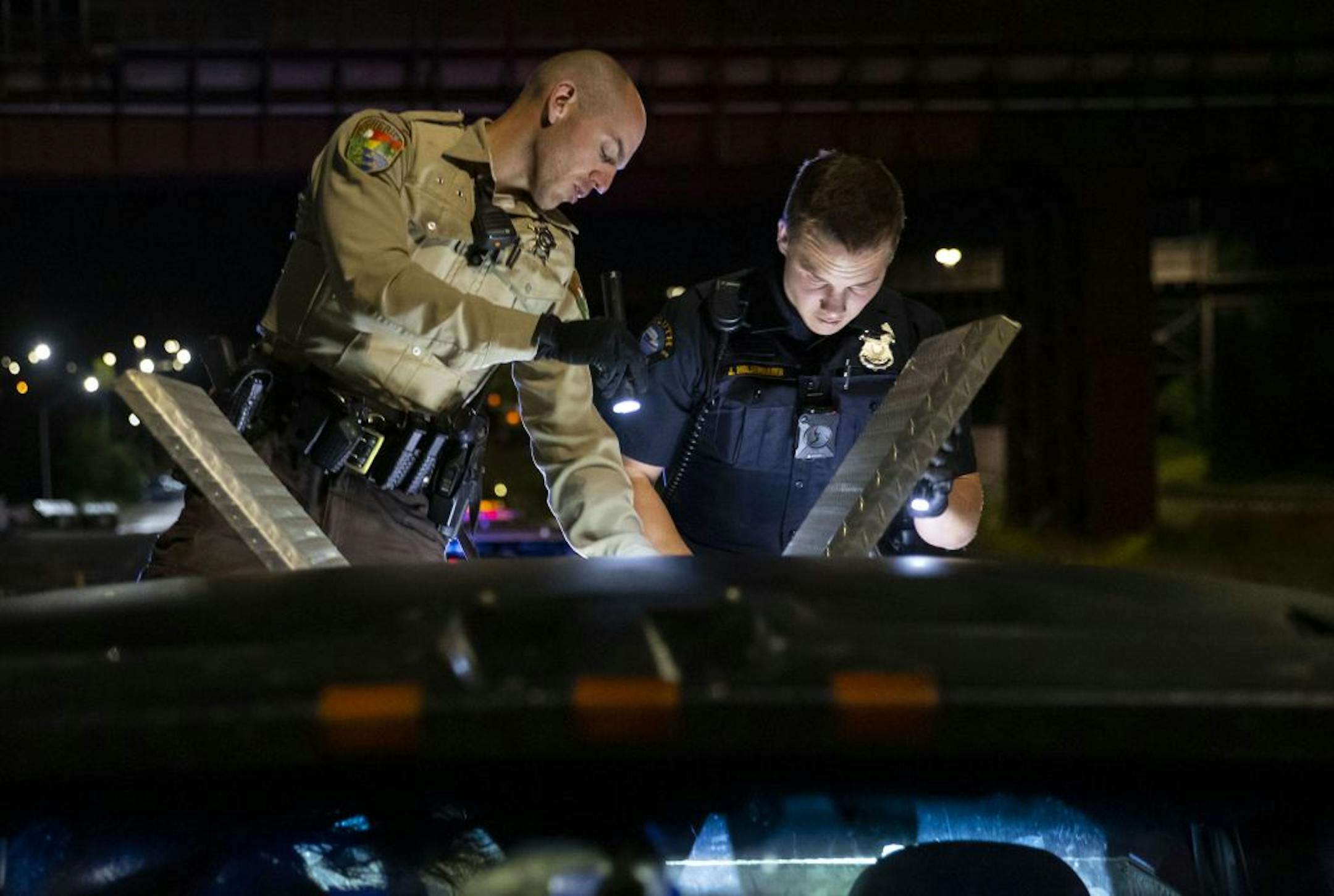 (Left) Deputy Ben Fye from the St. Louis County Sheriff's Office and Officer Jake Moldenhauer from the Duluth Police Department searched through a pickup truck suspected of having crystal meth hidden inside. Dayshift officers from the Duluth Police Department received intel early on Wednesday that a pickup truck matching this description and license plate would be transporting crystal meth later that night. Approximately one pound of meth was found in the truck.