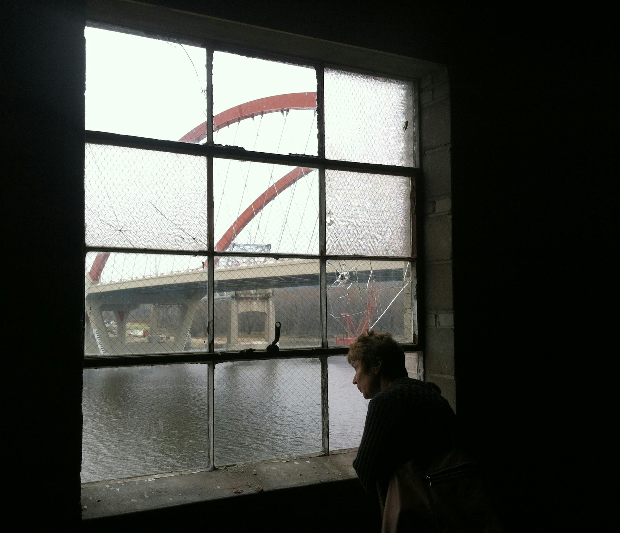 Lynn Renee, of Stillwater, gazes out of a second-story window of the historic H.D. Hudson Building in Hastings, which local officials hope to transform into a mix of retail and housing.