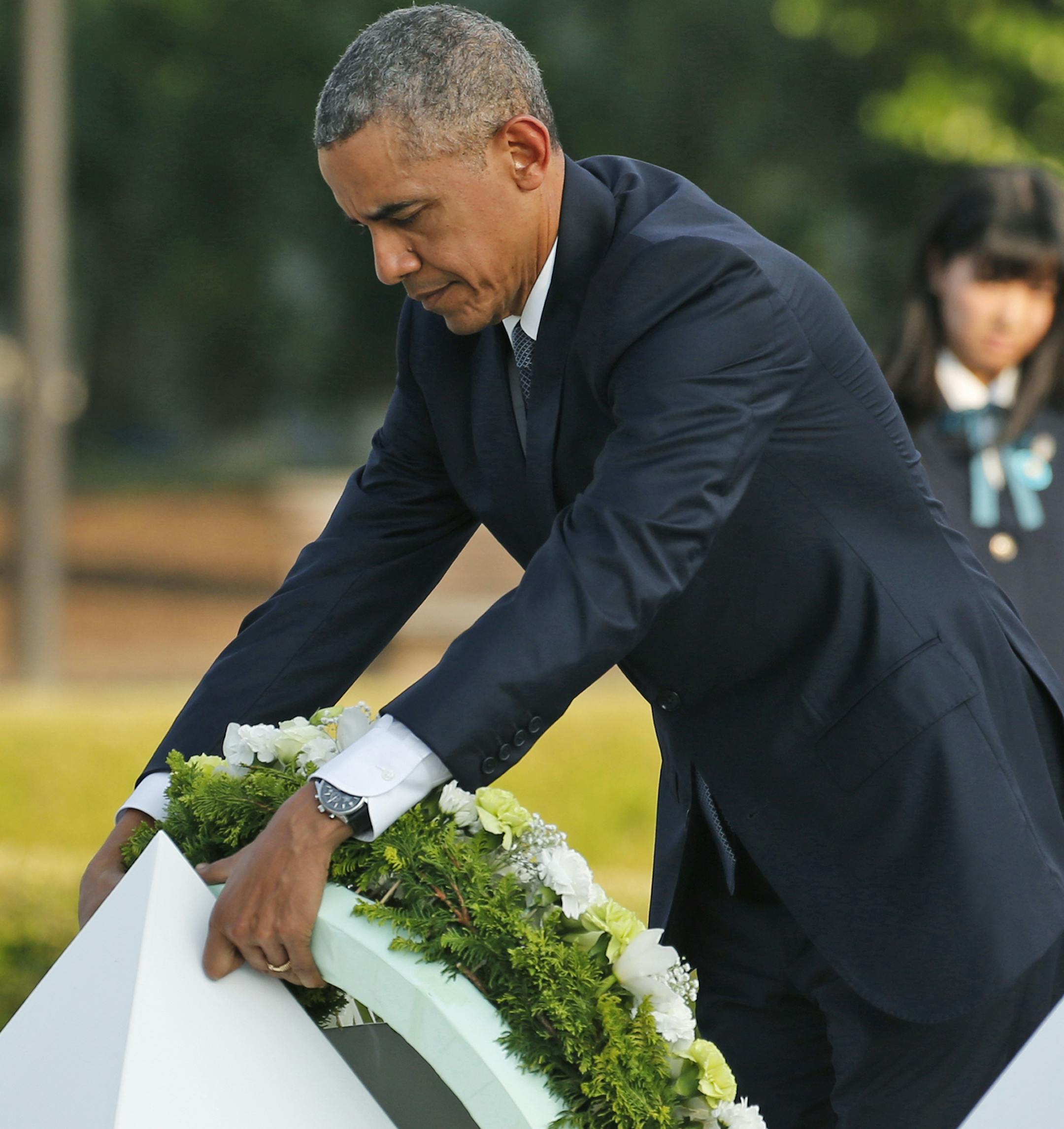 U.S. President Barack Obama lays wreaths at the cenotaph at Hiroshima Peace Memorial Park in Hiroshima, western Japan, Friday, May 27, 2016. Obama on Friday became the first sitting U.S. president to visit the site of the world's first atomic bomb attack, bringing global attention both to survivors and to his unfulfilled vision of a world without nuclear weapons. (AP Photo/Shuji Kajiyama)