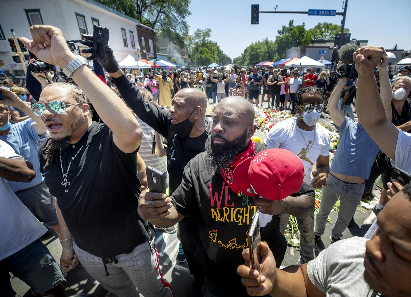 Community members along with Michael Brown (red hat) father of Mike Brown that was killed by police in Ferguson, celebrated the news that the 3 officers in the George Floyd murder had been arrested .] Jerry Holt •Jerry.Holt@startribune.com Reaction to charges against the of George Floyd at 38th an Chicago June 3, 2020 in Minneapolis,MN.