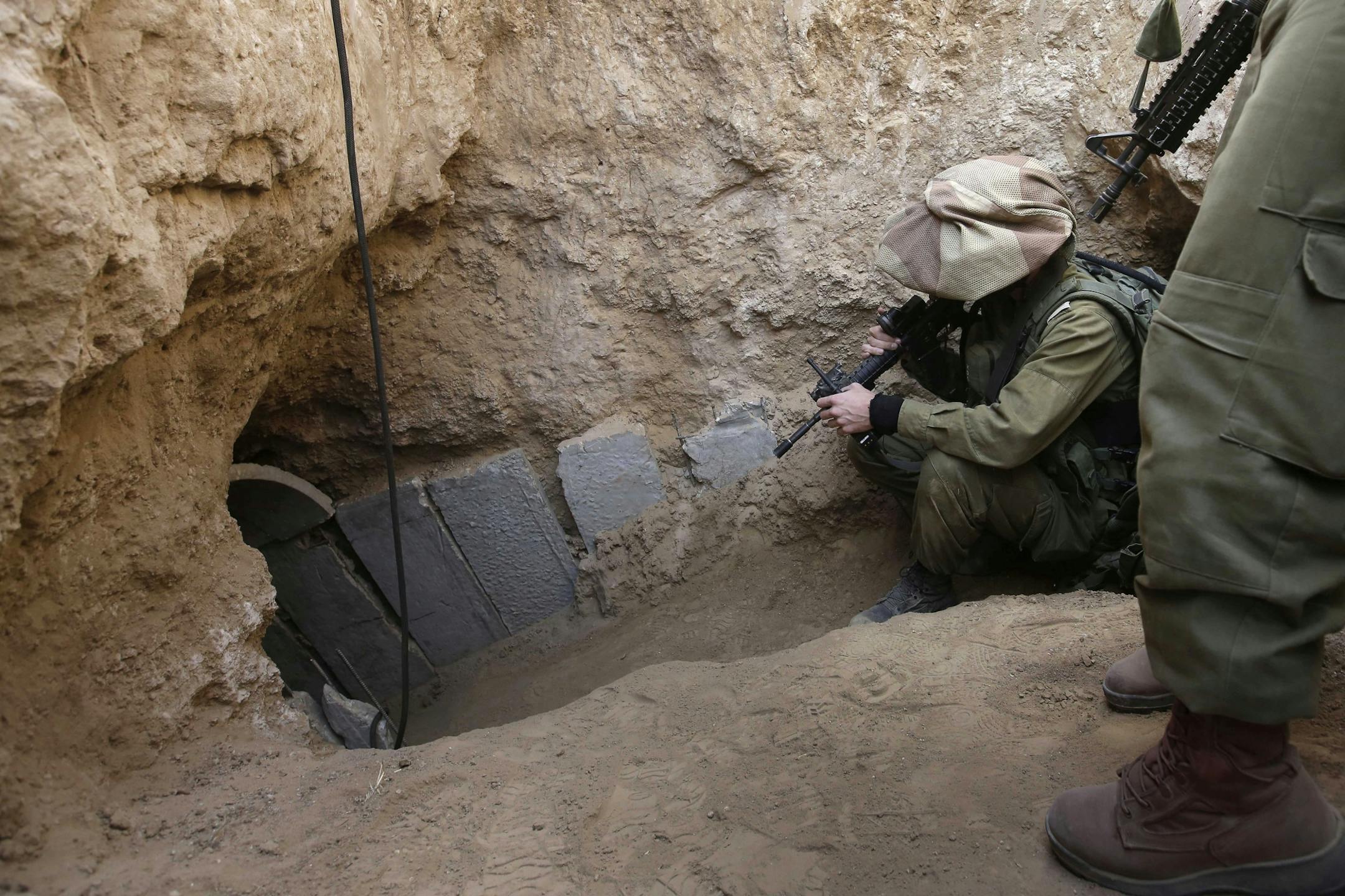 FILE - In this Sunday, Oct. 13, 2013 file photo, Israeli soldiers enter a tunnel discovered near the Israel Gaza border. They�ve been dubbed �lower Gaza,� compared to the Underground, the Metro or the subway and depicted as a bone-chilling, strategic threat to Israel. Hamas� web of tunnels is taking center stage in the relentless conflict between the militant group and Israel, with Israel�s ground offensive placing their destruction as a key objective.