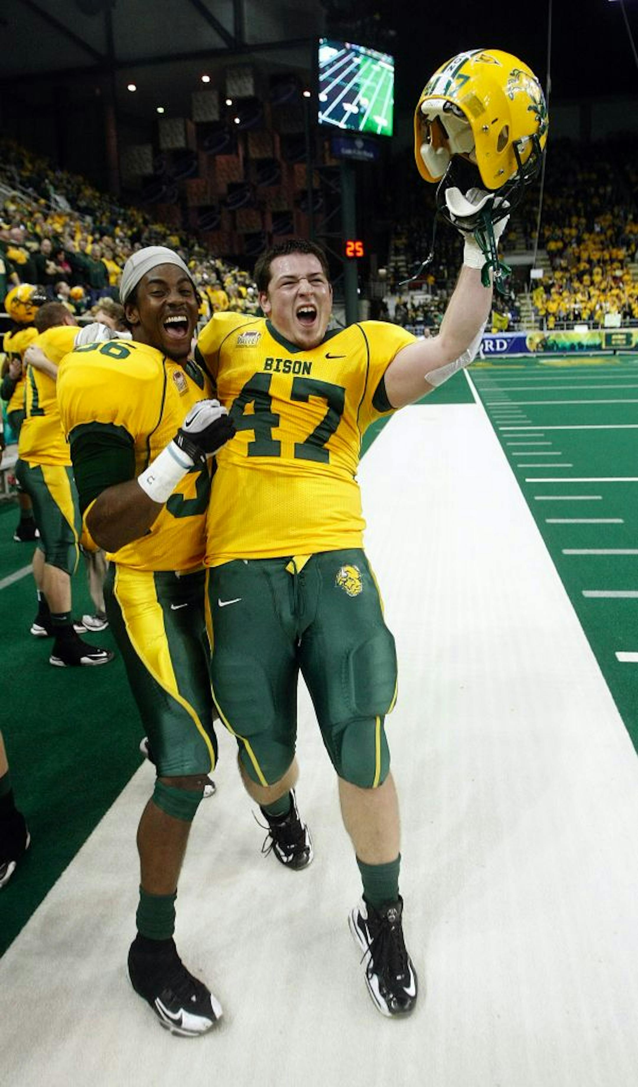 NDSU's Brandon Jemison, left, and Garrett Bruhn celebrated the Bison's FCS semifinal victory over Georgia Southern on Dec. 17.