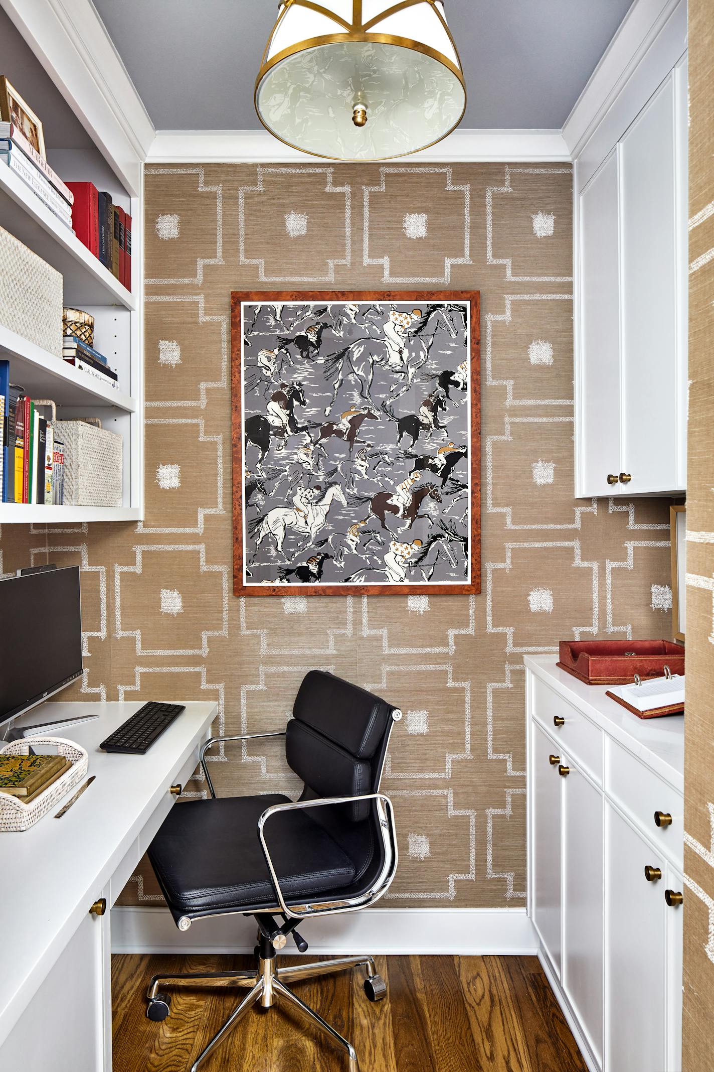 A Washington, D.C., condo cloffice by designers Pamela Black and Don Love has a grass-cloth wallpaper to add interest. The ceiling is painted in Benjamin Moore's Subway Tile. A piece of framed Herm's equestrian wallpaper makes a nice statement on the wall. MUST CREDIT: Stacy Zarin Goldberg/MoKi Media