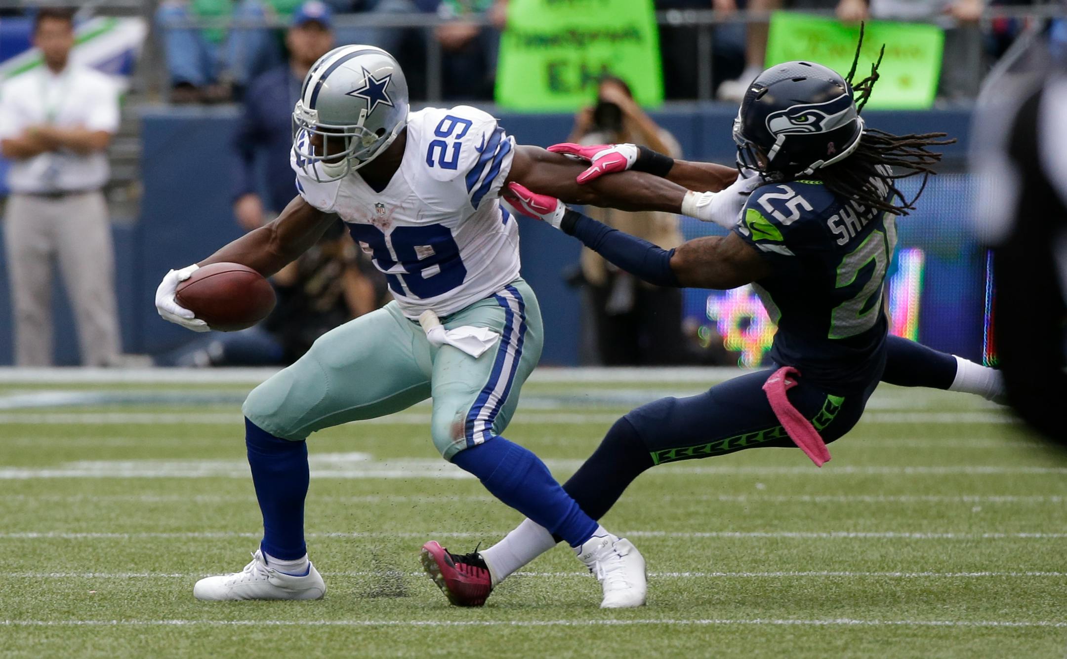 Dallas Cowboys running back DeMarco Murray, left, is tackled by Seattle Seahawks cornerback Richard Sherman, right, in the second half of an NFL football game, Sunday, Oct. 12, 2014, in Seattle. (AP Photo/Elaine Thompson)