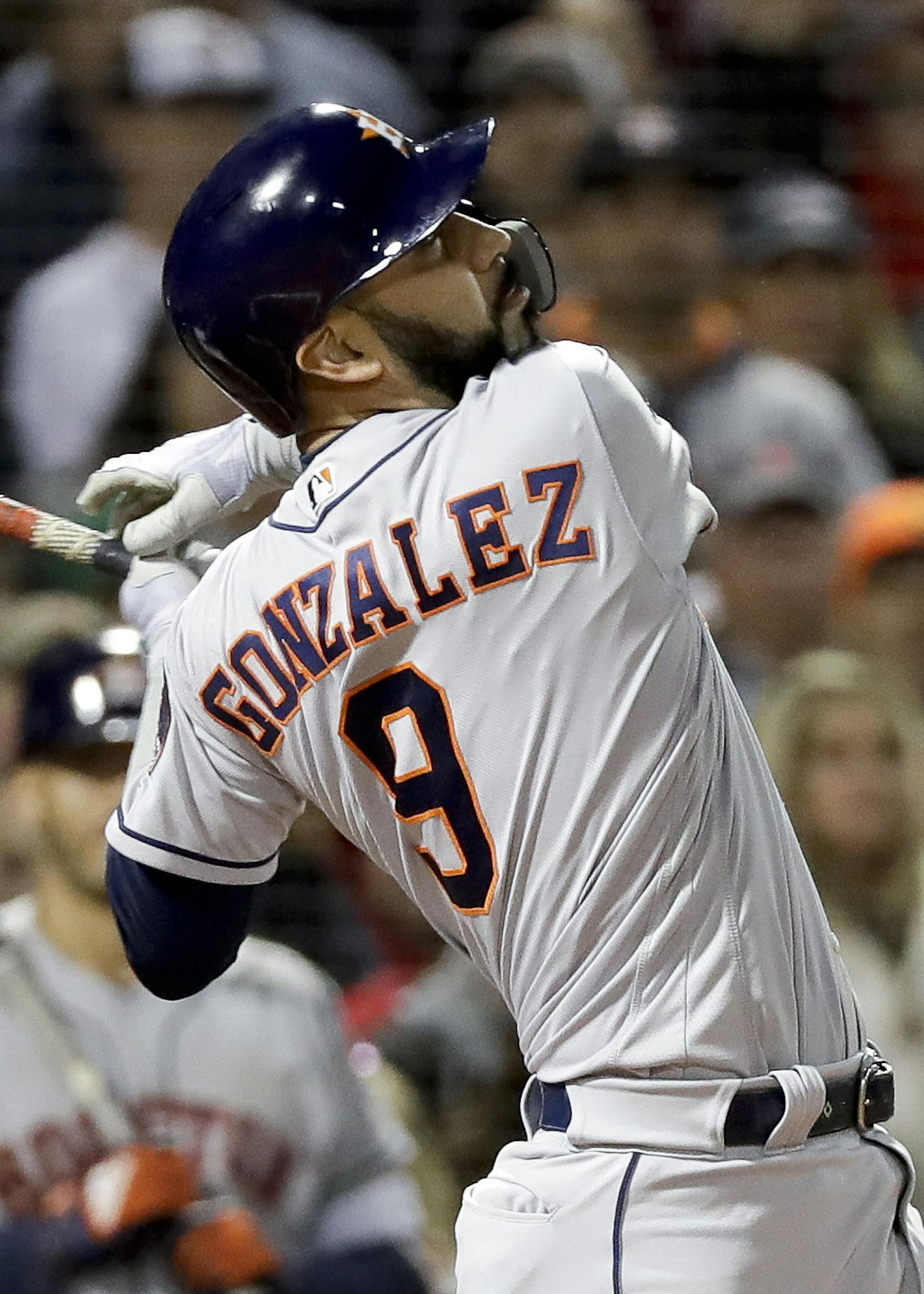 Houston Astros' Marwin Gonzalez watches his two-run home run against the Boston Red Sox during the third inning in Game 2 of a baseball American League Championship Series on Sunday, Oct. 14, 2018, in Boston. (AP Photo/David J. Phillip)