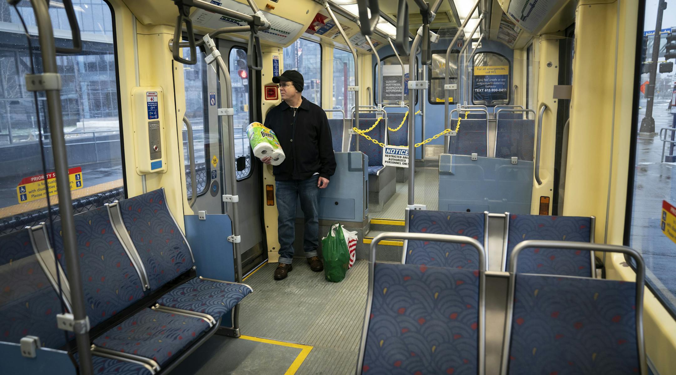 Peter Phillip rides an an almost empty Light Rail during the p.m. rush hour after collecting groceries in Minneapolis, Monday, April 13, 2020, during the coronavirus outbreak. (Renee Jones Schneider/Star Tribune via AP)