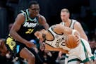 Boston Celtics forward Jayson Tatum (0) drives against Indiana Pacers' Jalen Smith (25) during the second half of an NBA basketball game, Tuesday, Jan