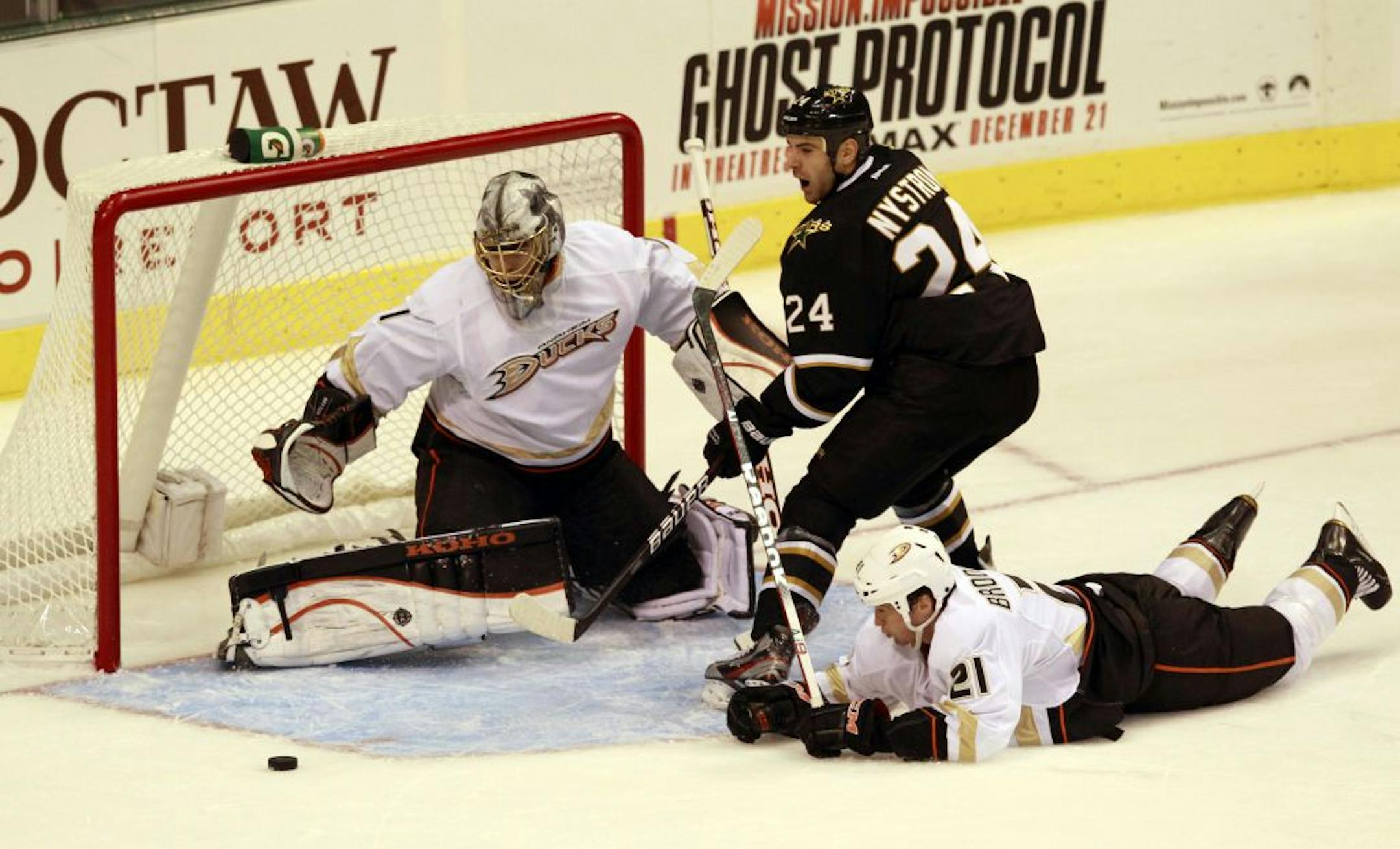 Dallas Stars left wing Eric Nystrom (24) misses a shot on Anaheim Ducks goalie Jonas Hiller (1) as defenseman Sheldon Brookbank (21) dives for the puck during the 1st period of their NHL hockey game at American Airlines Center in Dallas, Texas, on Monday, December 19, 2011.